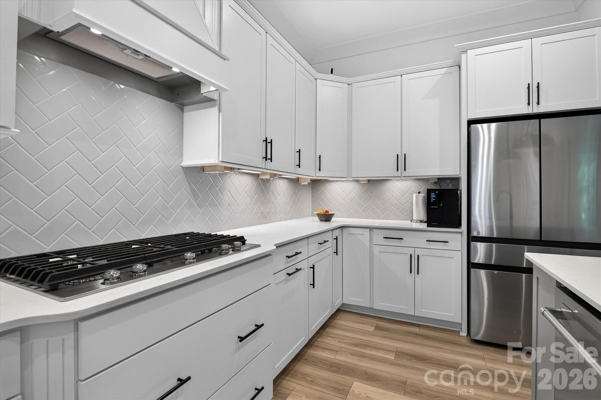 Herringbone backsplash that makes even weeknight cooking feel like a moment. This kitchen was built to be used. - 1216 Glade Arch Lane, Huntersville