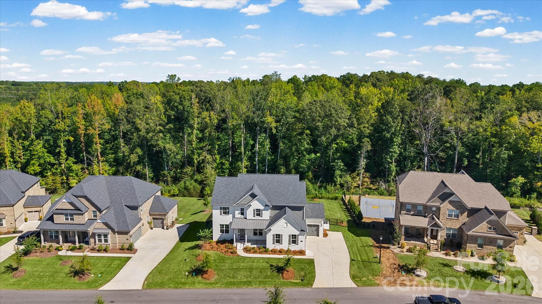 Mature trees as your backdrop, this is the kind of curb arrival that makes you slow down before you even park. - 1216 Glade Arch Lane, Huntersville