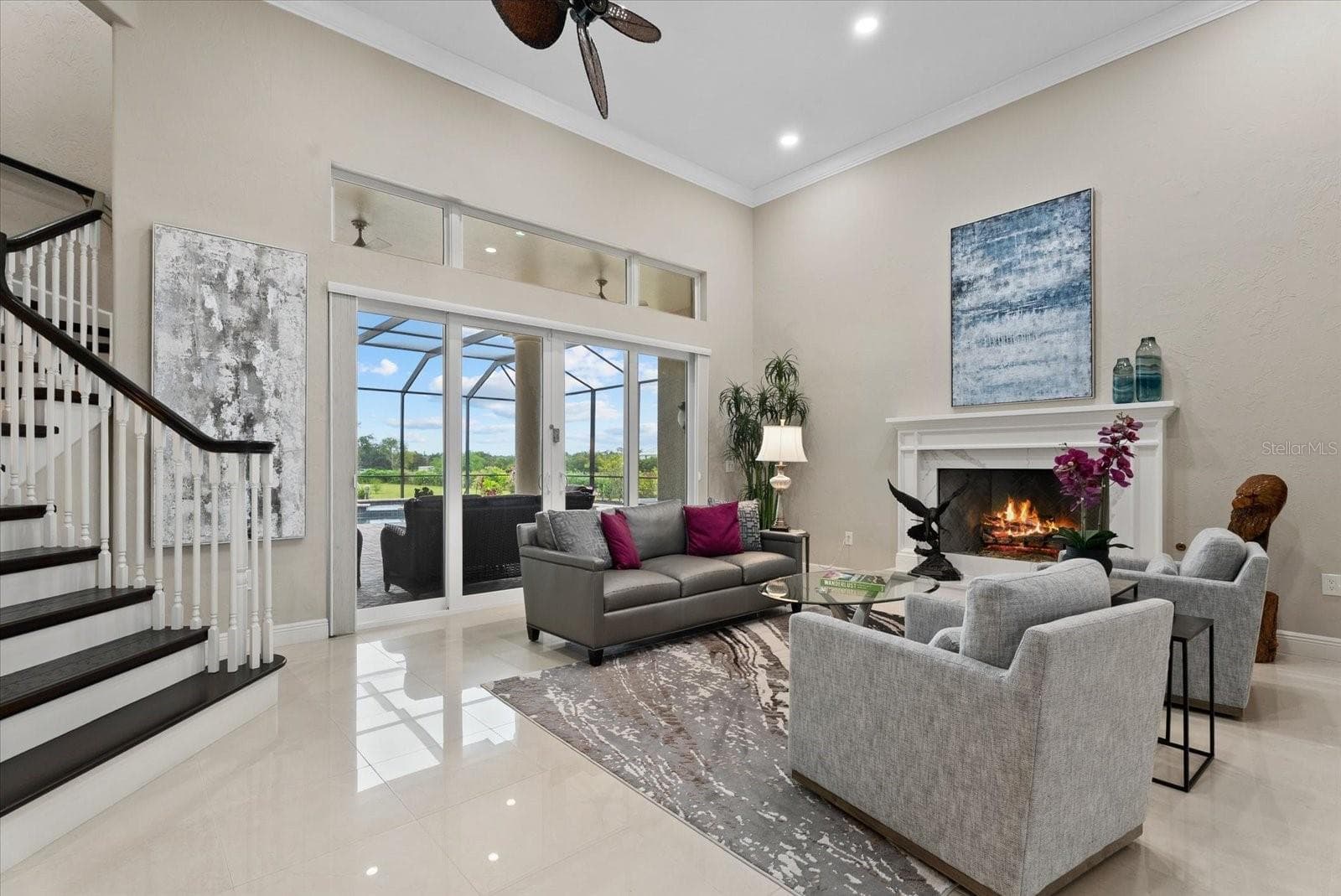 A gas fireplace provides a cozy setting for the a large living room - 520 RYE RD NE, BRADENTON