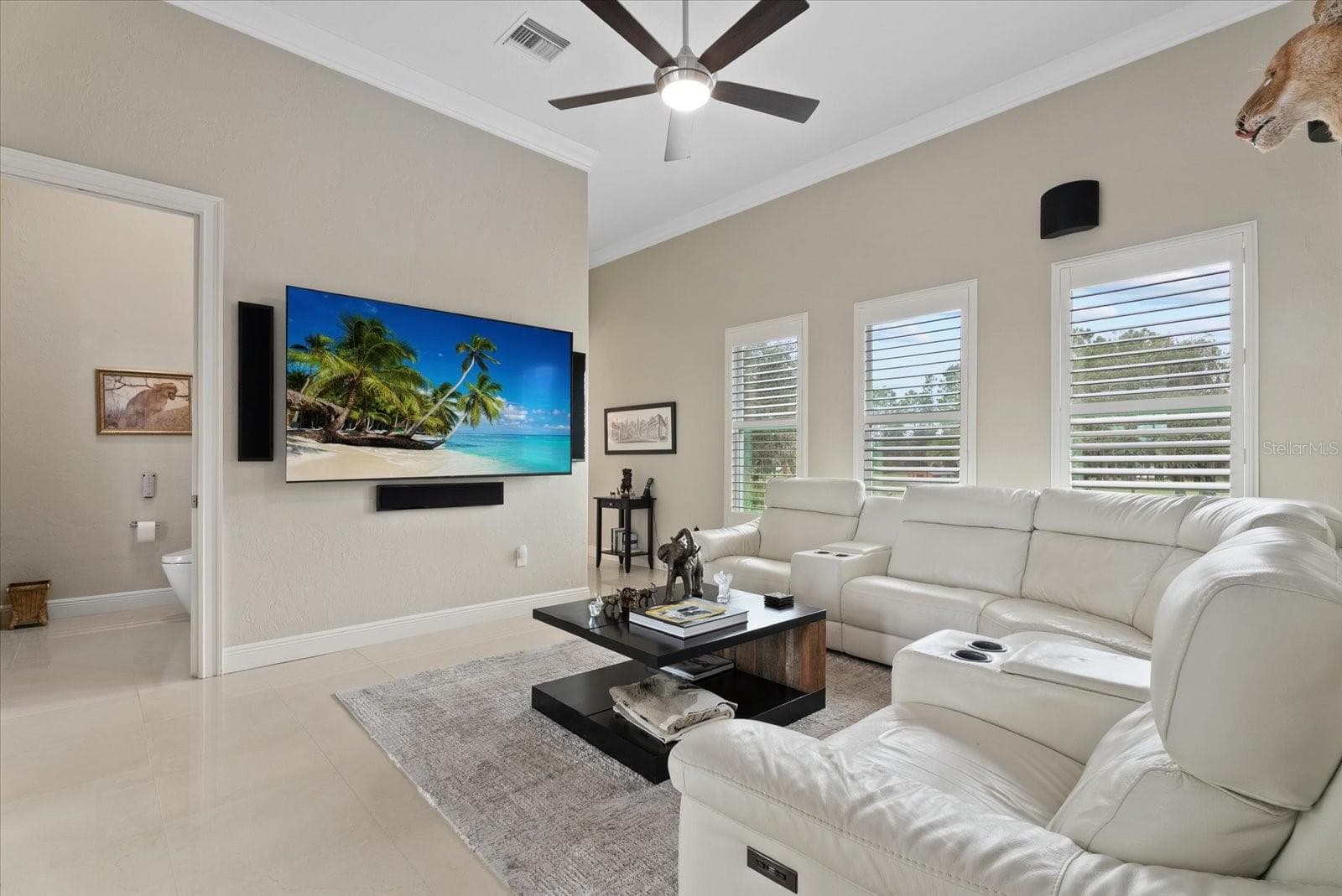 The view shows the media room, and the hall bath that opens to the pool deck - 520 RYE RD NE, BRADENTON