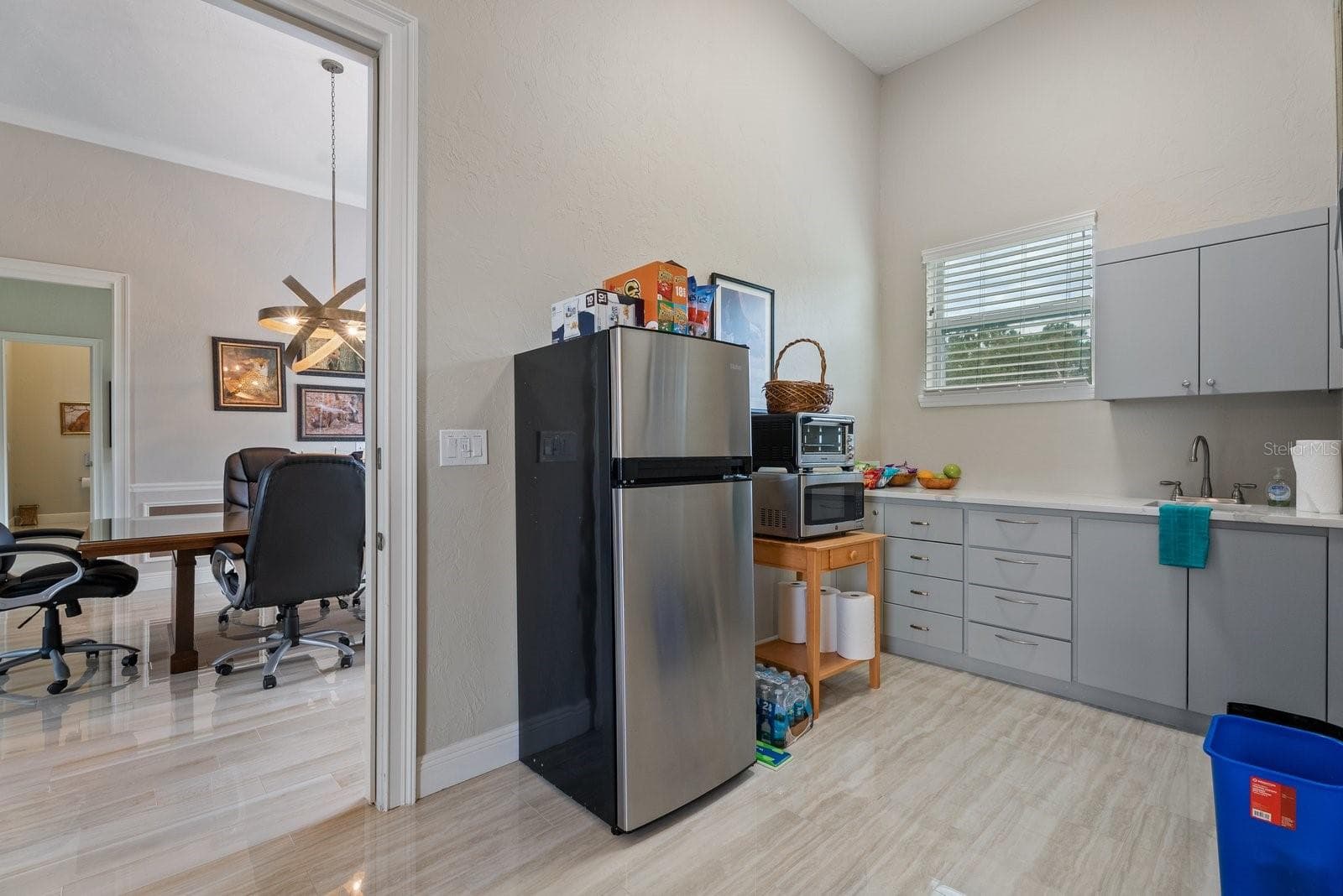 Kitchenette in the inlaw suite, showing the access door to the flex space conference room and door into the media room. Either door can be locked off to make the inlaw suite either a studio or a one bedroom apt. - 520 RYE RD NE, BRADENTON