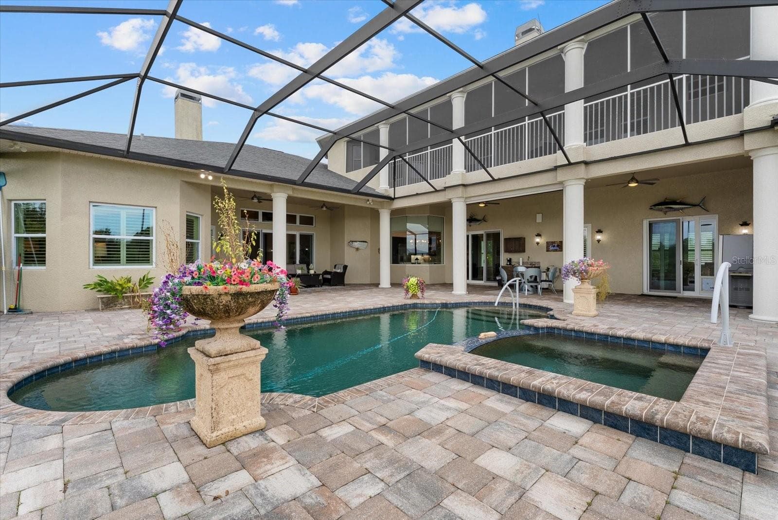 Enjoy the heated spa that spills over into the pool - 520 RYE RD NE, BRADENTON