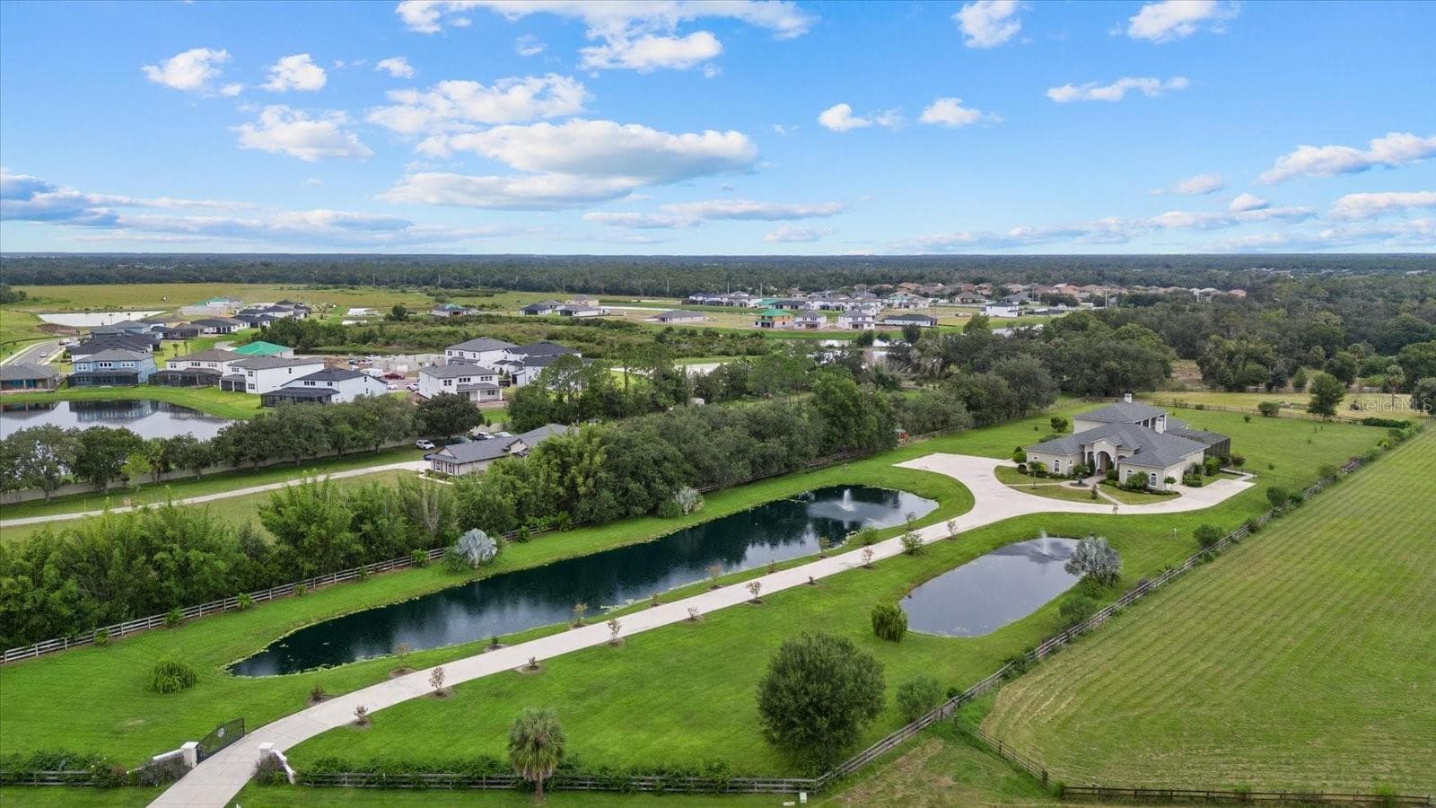 The drone photo gives a nice perspective of the long driveway and two ponds - 520 RYE RD NE, BRADENTON
