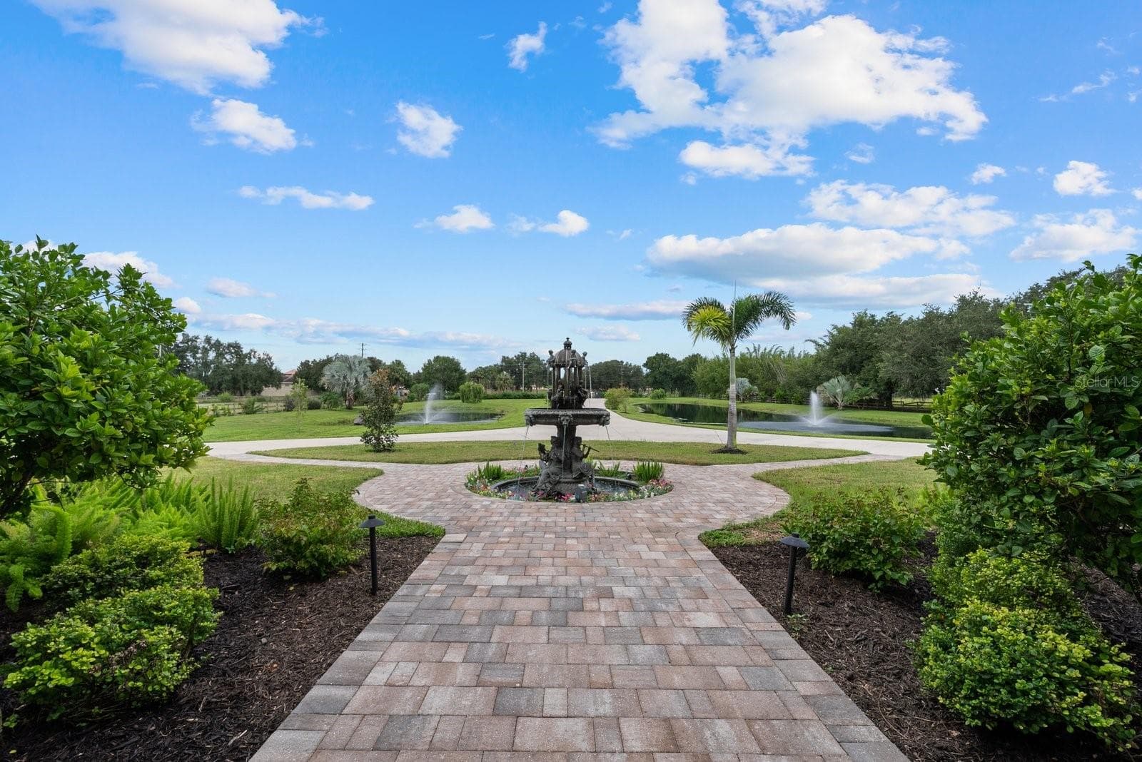 Looking out from the front door towards the large bronze fountain, ponds and driveway - 520 RYE RD NE, BRADENTON