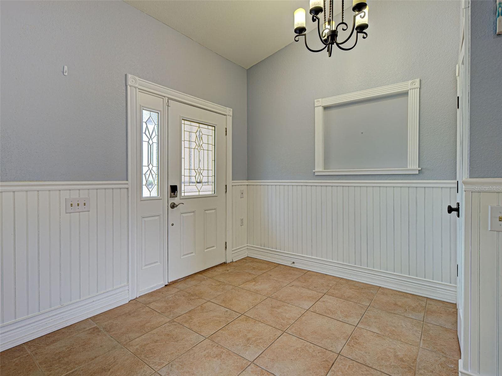 The front door opens into a spacious foyer with a closet. - 23102 MADELYN AVE, PORT CHARLOTTE