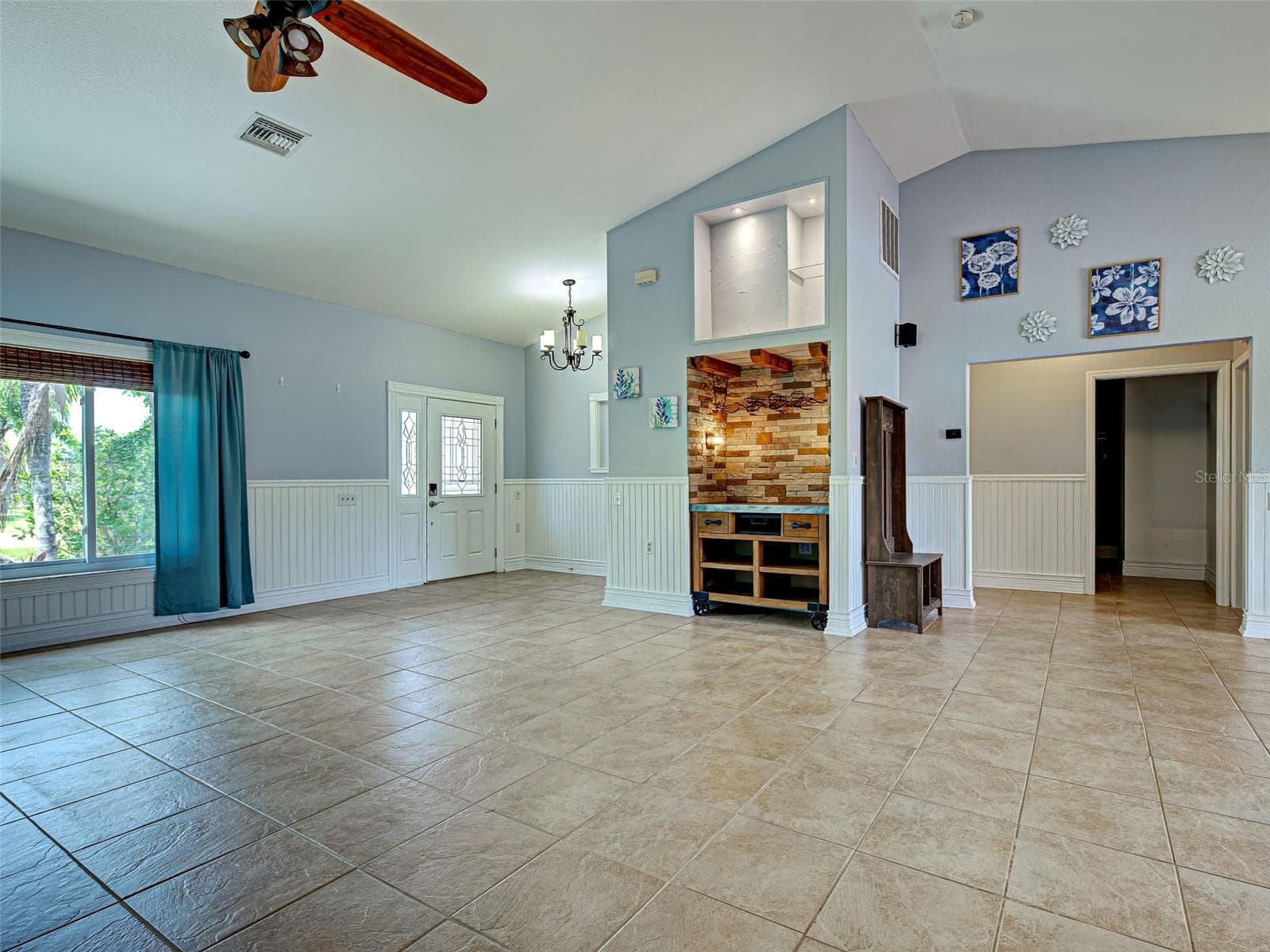 There is a dry bar in the Great Room, tastefully surrounded by brick. - 23102 MADELYN AVE, PORT CHARLOTTE