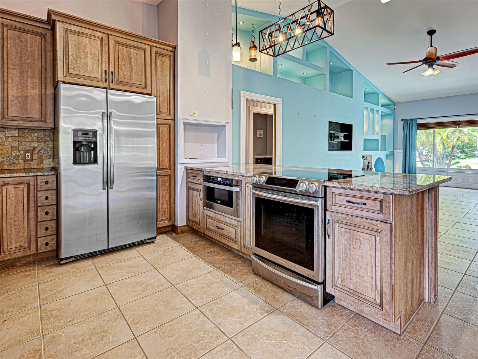 The spacious kitchen is perfect for preparing meals and socializing with family and friends. - 23102 MADELYN AVE, PORT CHARLOTTE