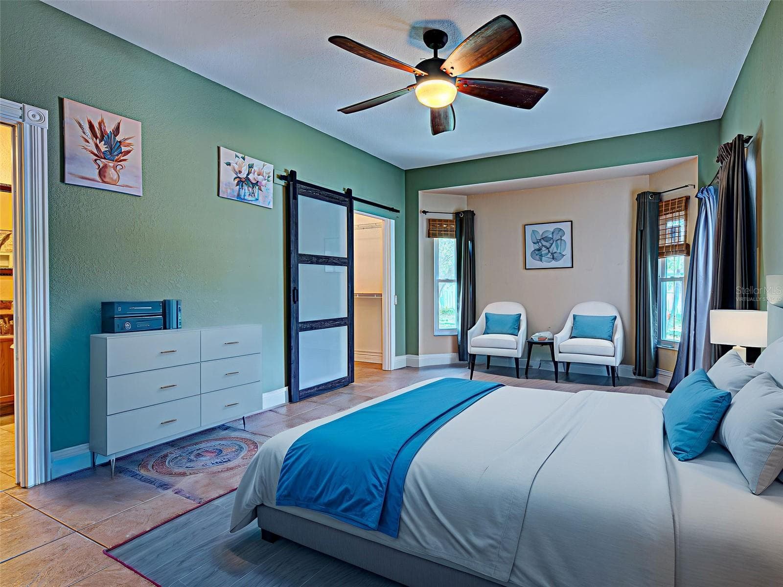 Virtually staged The primary bedroom has a unique space-saving barn door and an en-suite bathroom, - 23102 MADELYN AVE, PORT CHARLOTTE