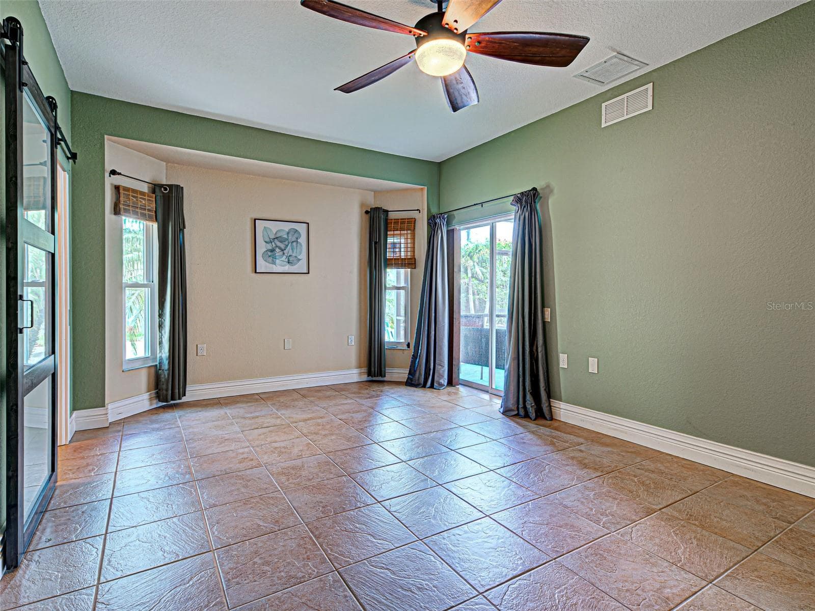 There is a sliding glass door from the primary bedroom to the lanai. - 23102 MADELYN AVE, PORT CHARLOTTE