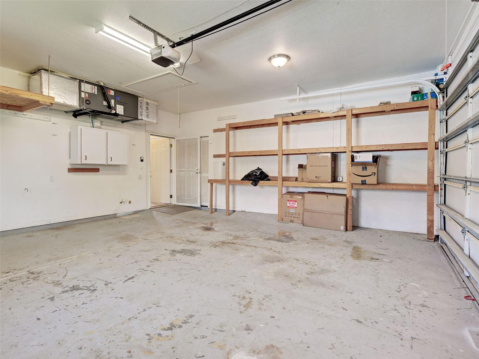 There is space in the garage for wall cabinets and storage shelves. - 23102 MADELYN AVE, PORT CHARLOTTE