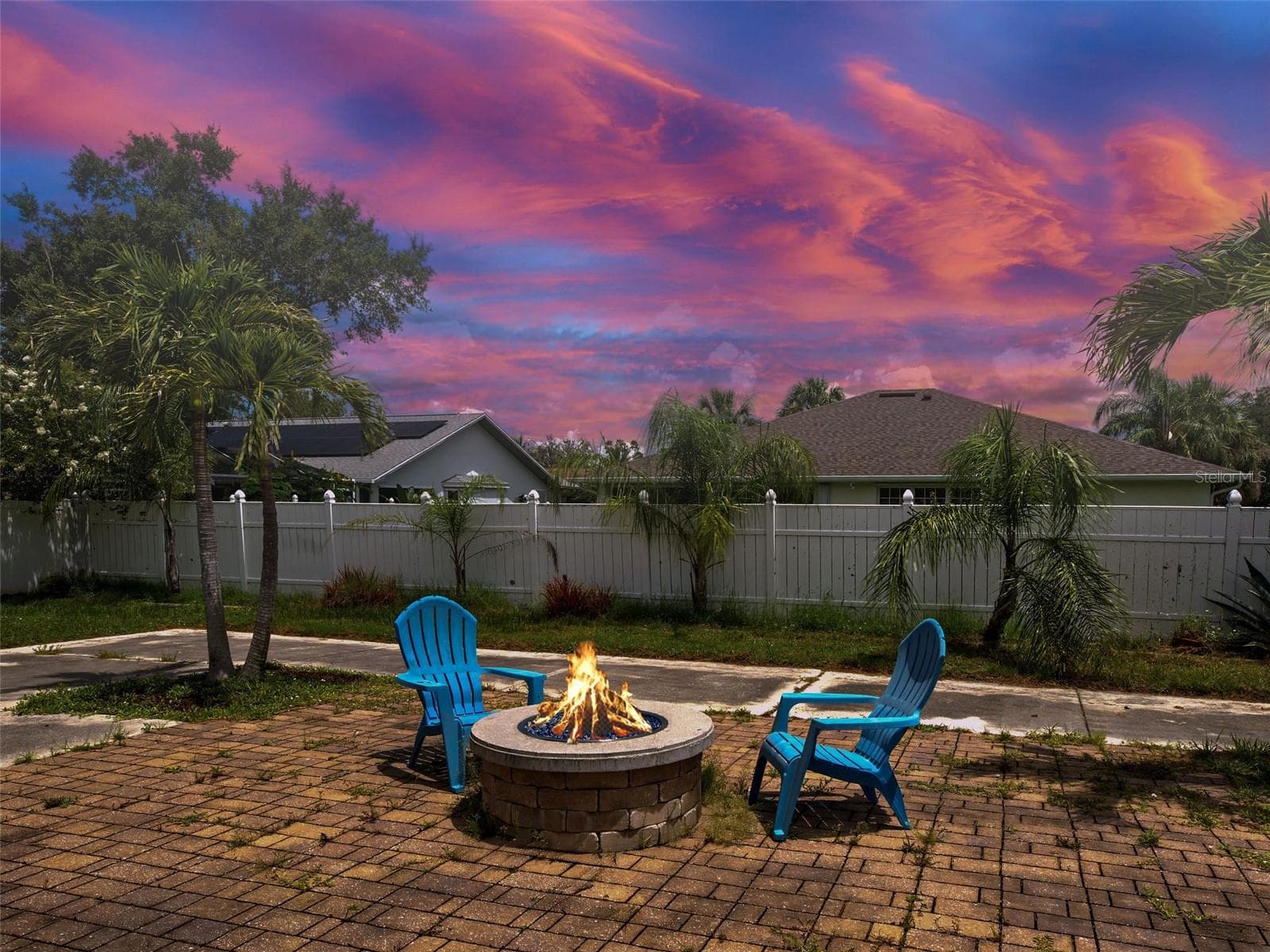 The yard has a huge brick patio with a gas firepit. - 23102 MADELYN AVE, PORT CHARLOTTE