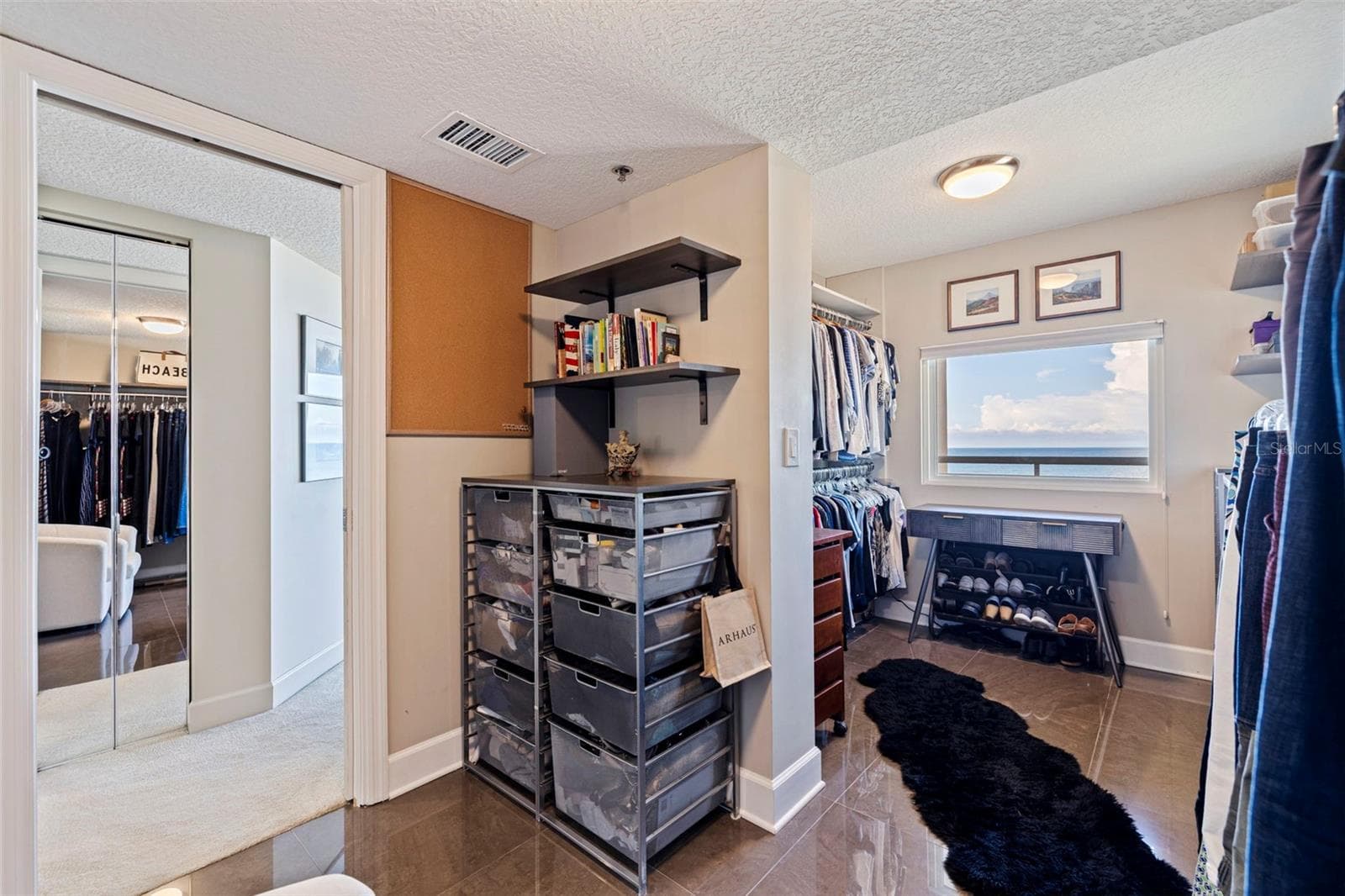 Custom designed primary walk-in closet  with view of the Gulf - 19616 GULF BLVD #302, INDIAN SHORES