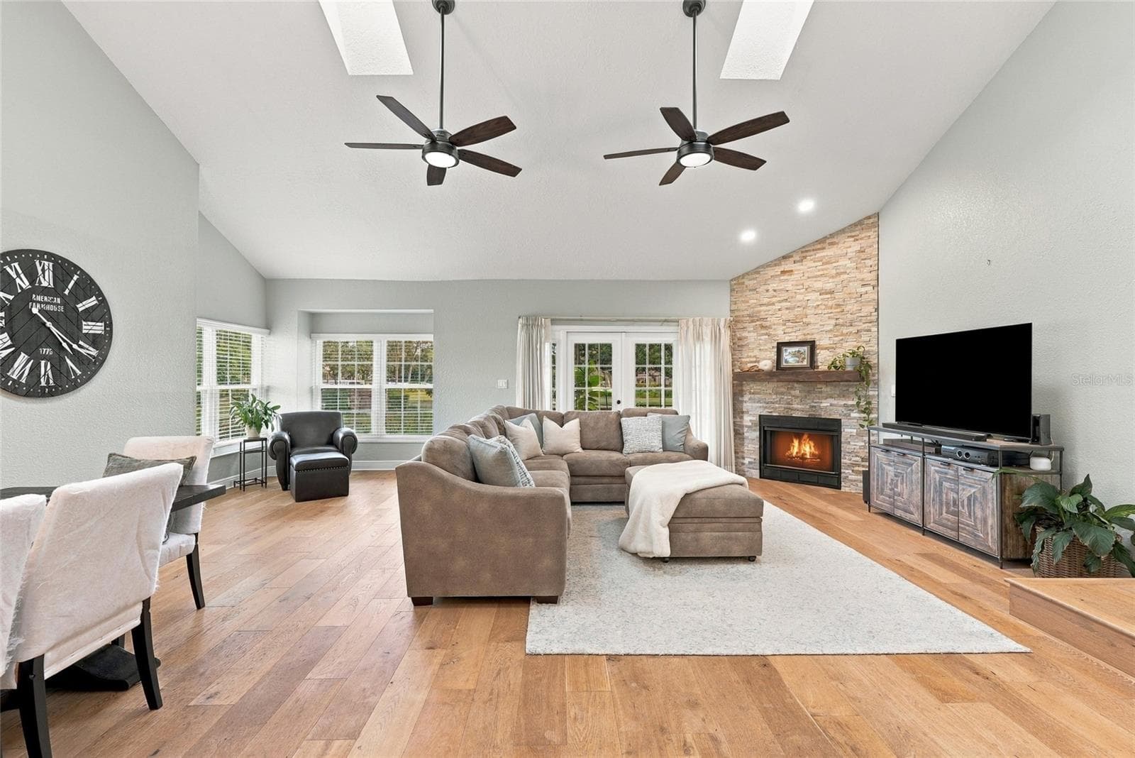 A custom stone fireplace creates a warm focal point within the home’s spacious main living area. - 629 SEGOVIA CT NE #405, ST PETERSBURG