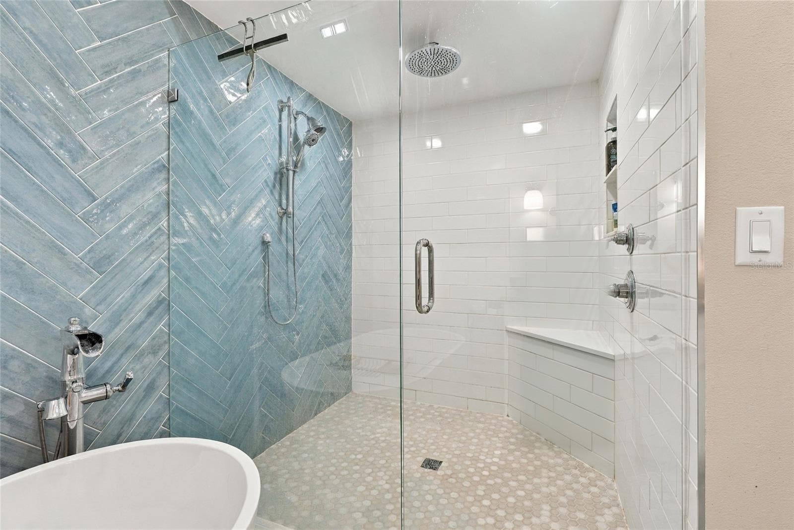 Spa-inspired glass-enclosed shower with a rainfall showerhead and handheld wand. - 629 SEGOVIA CT NE #405, ST PETERSBURG