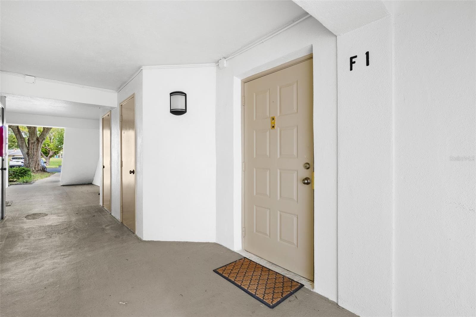 Unit F1 offers convenient first-floor living with a covered entry and no stairs to navigate. - 3188 LAKE PINE WAY S #F1, TARPON SPRINGS
