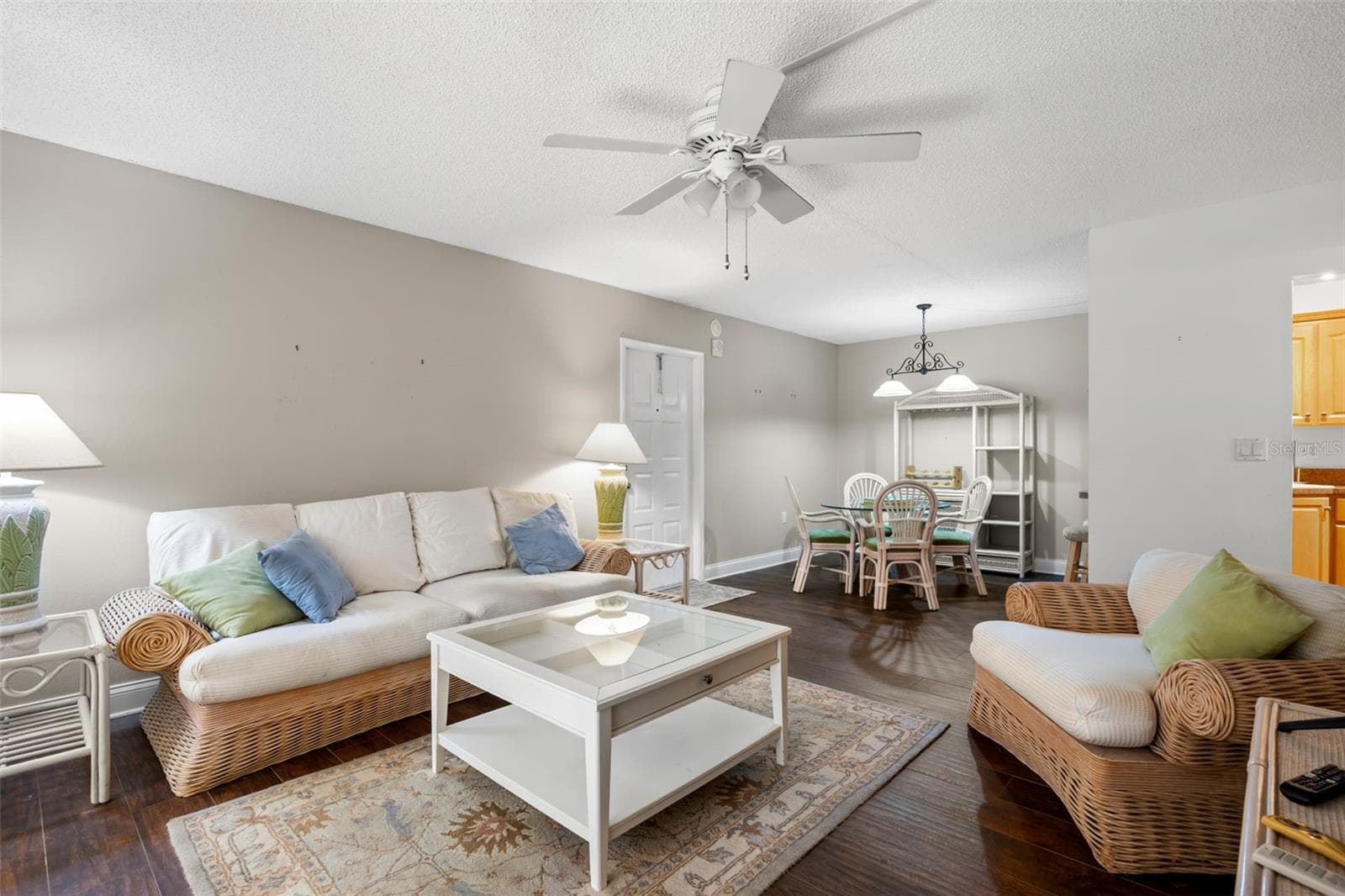 The 13'7" x 15'4" living room offers plenty of space for comfortable seating, while the adjoining dining area creates a natural spot for everyday meals or entertaining. - 3188 LAKE PINE WAY S #F1, TARPON SPRINGS