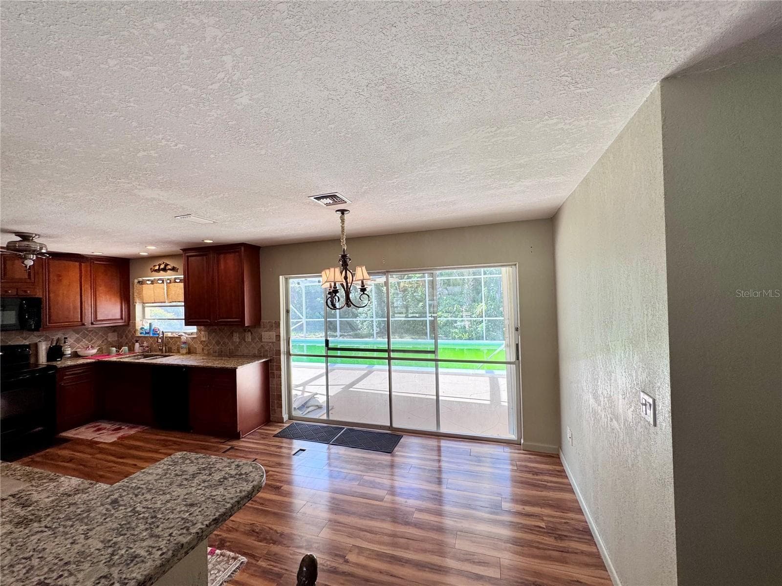Kitchen/dining area with sliders out to pool - 22215 ONEIDA AVE, PORT CHARLOTTE