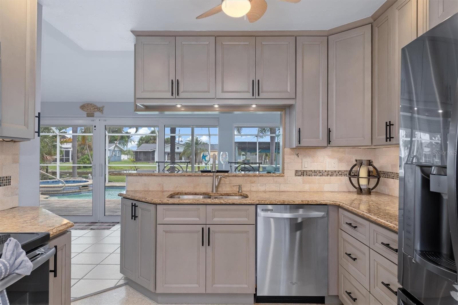 working in this kitchen almost every view is pool & canal - 1433 LEMON BAY DR, ENGLEWOOD