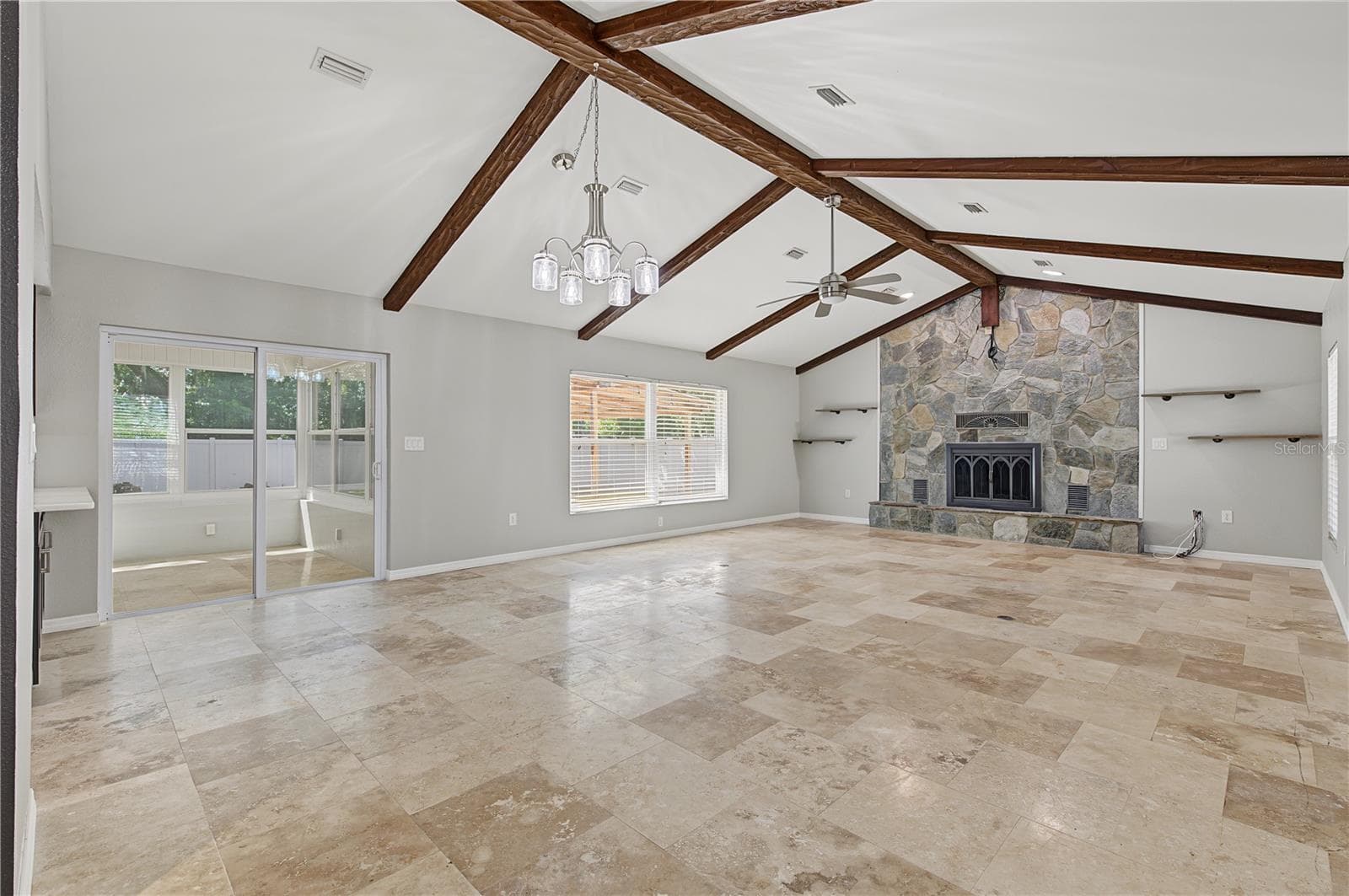 Open-concept living space with generous square footage, updated flooring, and distinctive exposed ceiling beams. - 260 SE 16TH TER, CRYSTAL RIVER