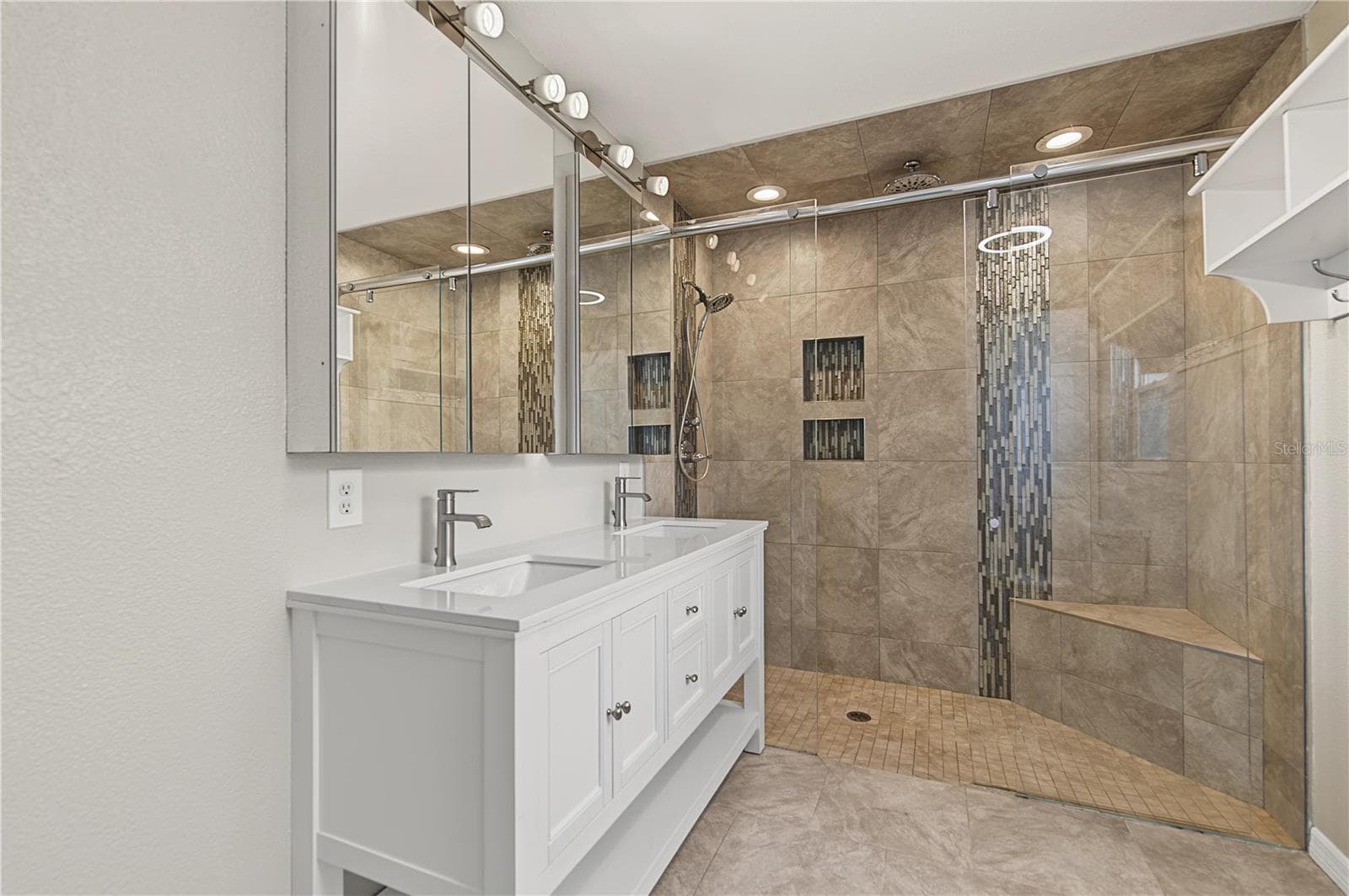Stylish bathroom featuring a glass-enclosed shower, decorative tile, and modern vanity. - 260 SE 16TH TER, CRYSTAL RIVER