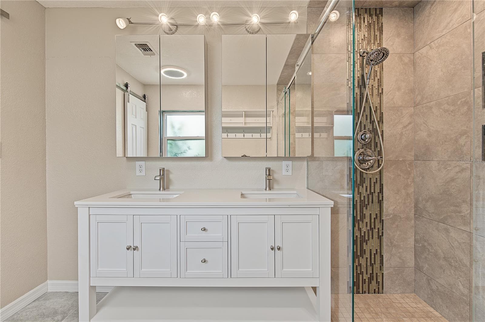 Beautifully updated bathroom with dual sinks, contemporary lighting, and a spacious tiled shower. - 260 SE 16TH TER, CRYSTAL RIVER