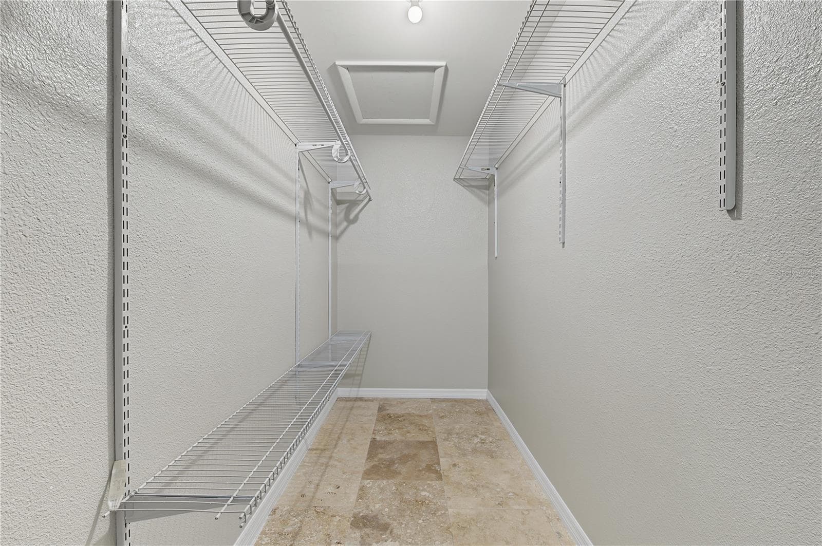 Spacious walk-in closet featuring built-in shelving and multiple hanging areas for organized storage. - 260 SE 16TH TER, CRYSTAL RIVER