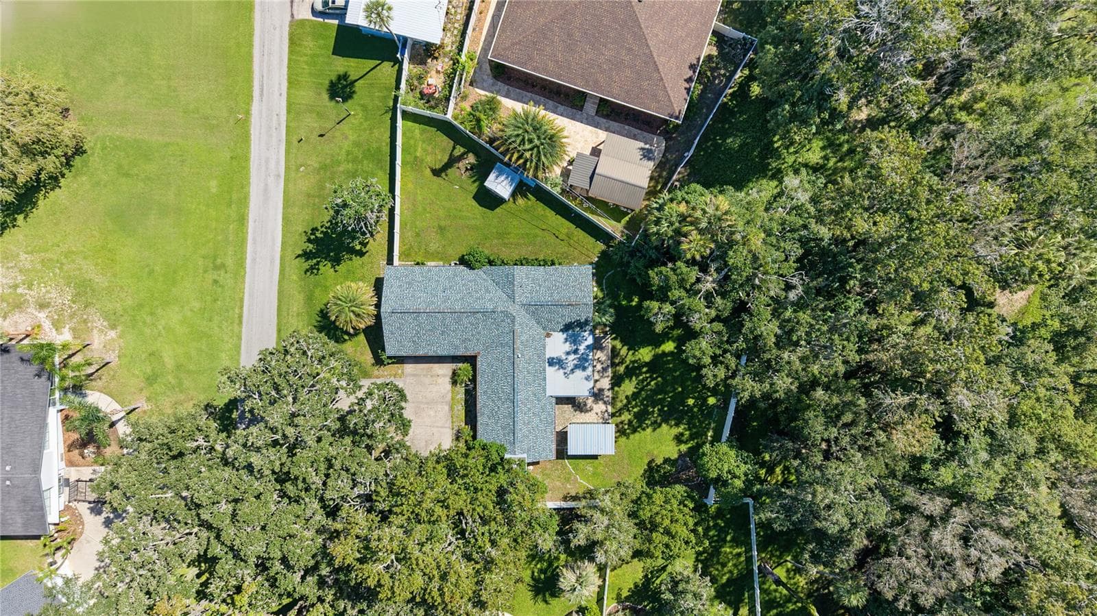 Overhead aerial perspective showcasing the home's footprint, yard configuration, and surrounding landscaping. - 260 SE 16TH TER, CRYSTAL RIVER