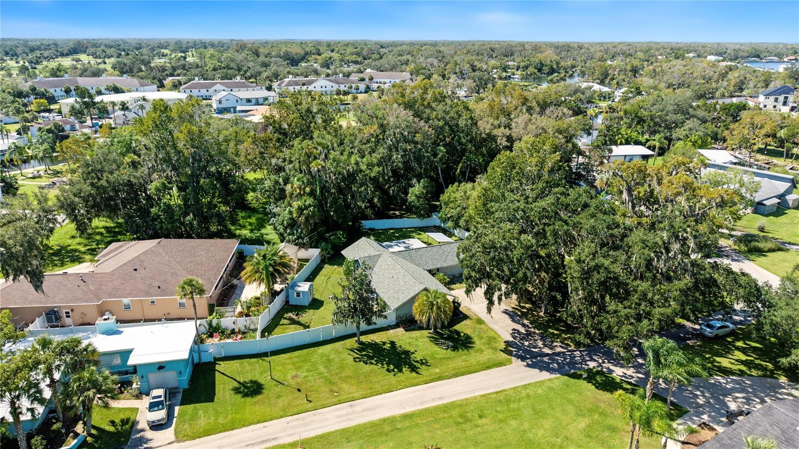 Aerial view highlighting the property's residential setting, surrounding greenery, and nearby waterways. - 260 SE 16TH TER, CRYSTAL RIVER