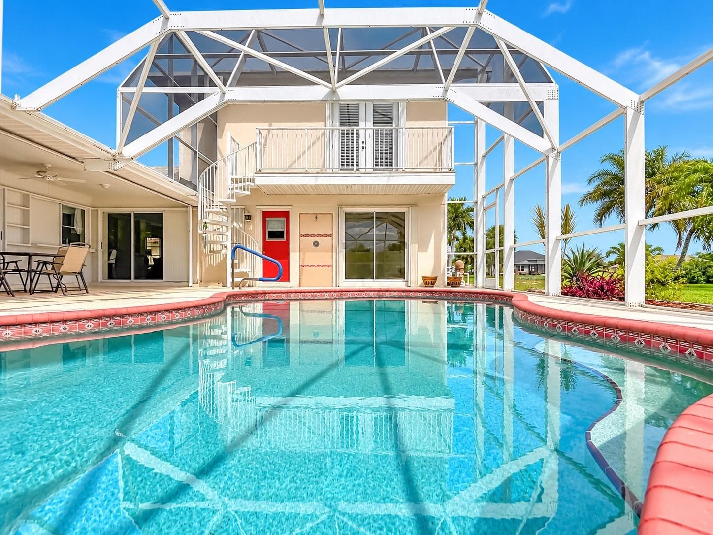 2. Screened pool with views of the rear exterior and upper balcony. - 63 CLUBHOUSE RD, ROTONDA WEST