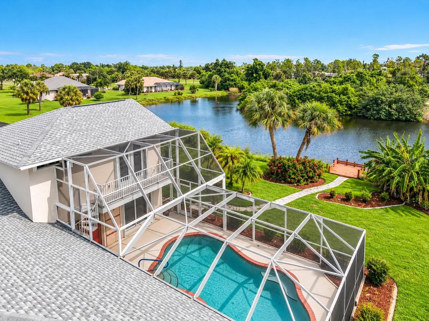 Aerial view of the home, screened pool, and pond - 63 CLUBHOUSE RD, ROTONDA WEST