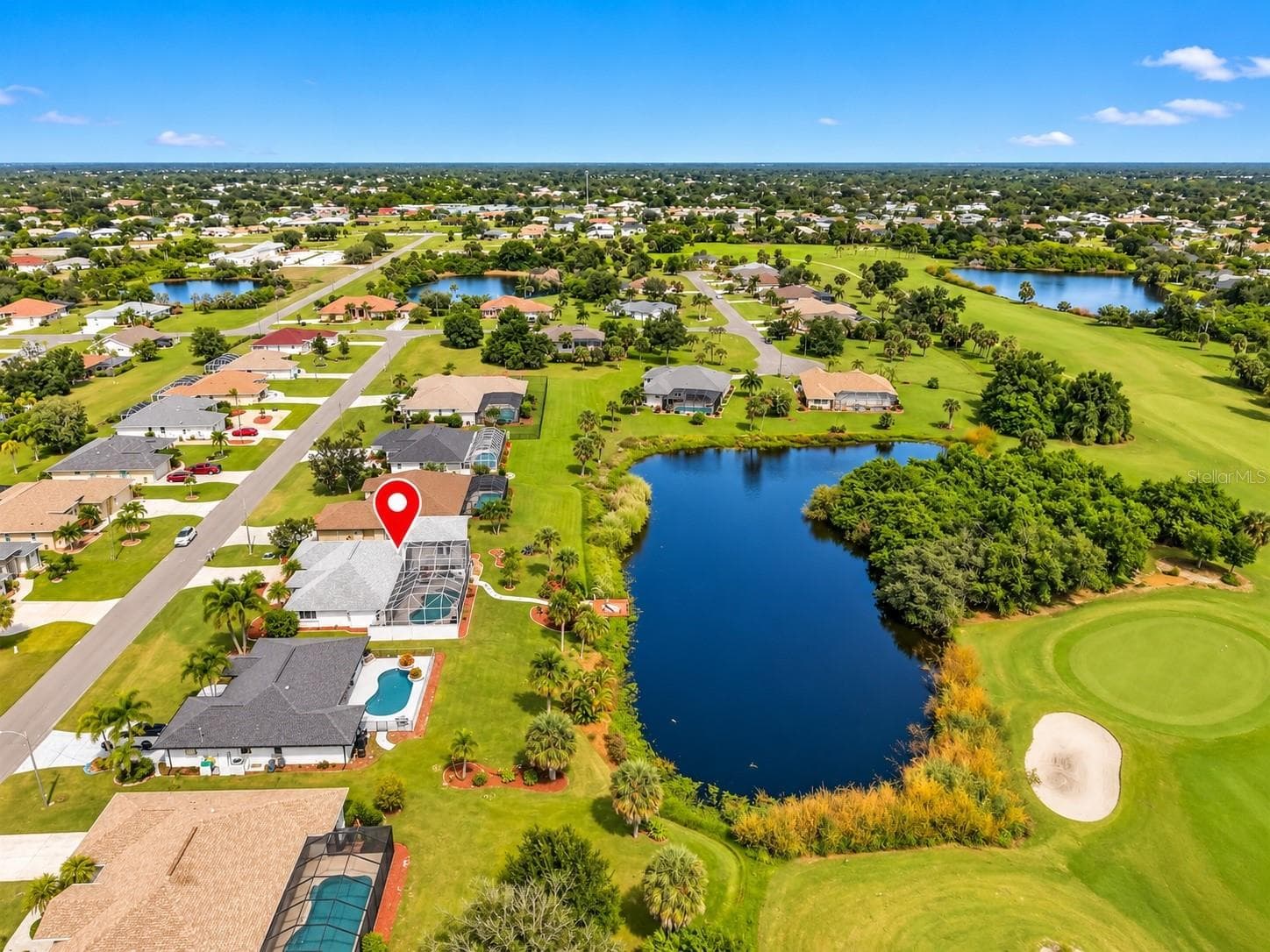 4. Aerial view of the surrounding neighborhood and ponds. - 63 CLUBHOUSE RD, ROTONDA WEST
