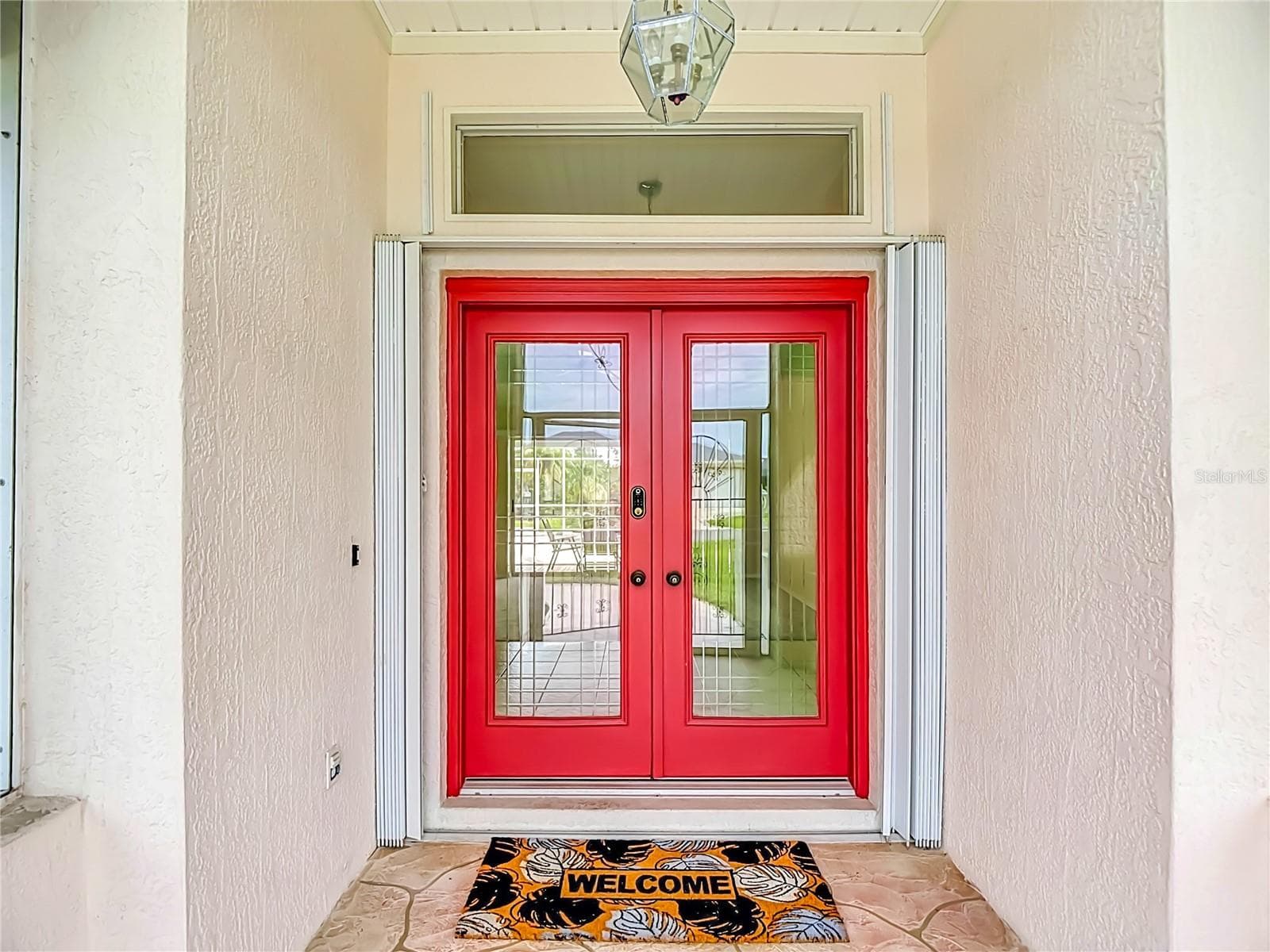 7. Covered entry with red double doors. - 63 CLUBHOUSE RD, ROTONDA WEST