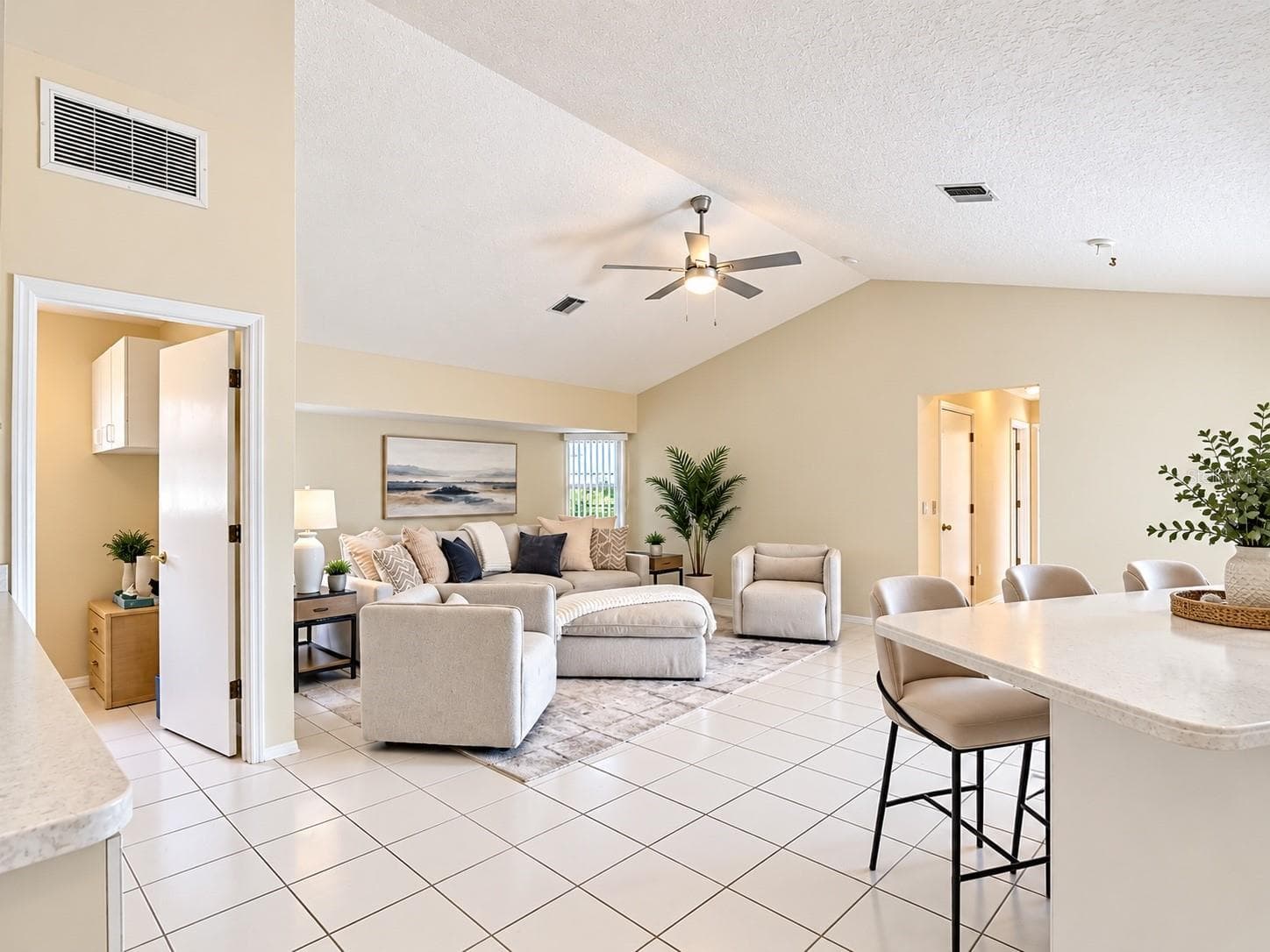 8. Living room with sliding glass doors and natural light. - 63 CLUBHOUSE RD, ROTONDA WEST