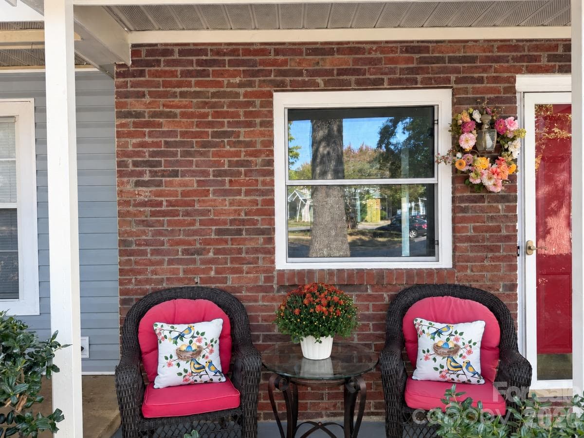 A welcoming porch seating area adds charm before you even step inside. - 3858 Mosscroft Lane, Charlotte