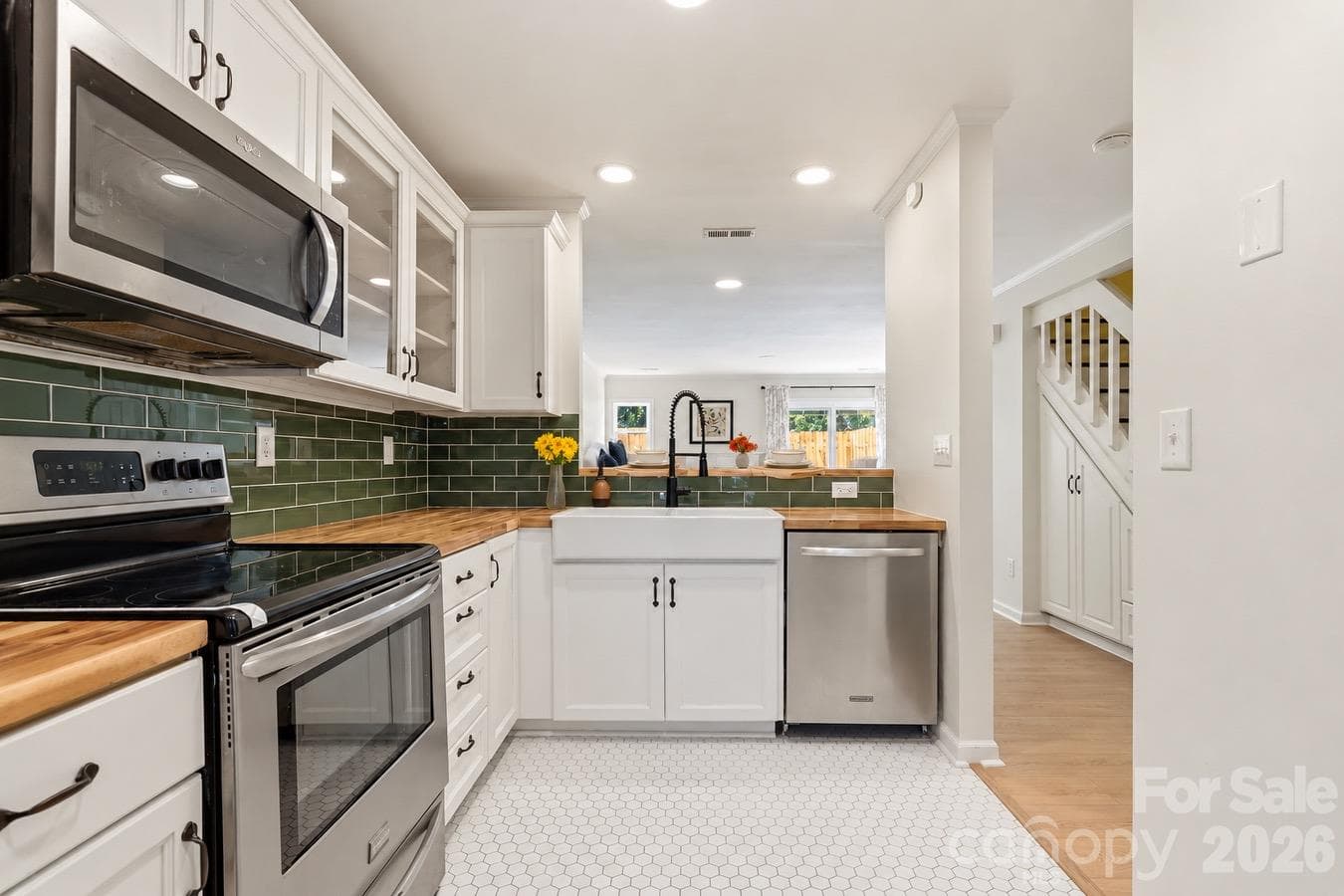 Handmade cabinets bring character and thoughtful craftsmanship to the renovated kitchen. - 3858 Mosscroft Lane, Charlotte