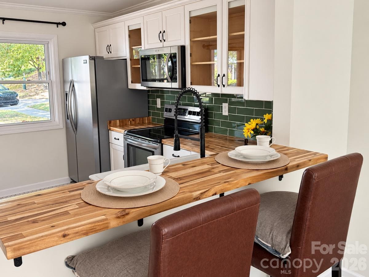 A welcoming spot for everyday meals, morning coffee, and gathering with friends. - 3858 Mosscroft Lane, Charlotte