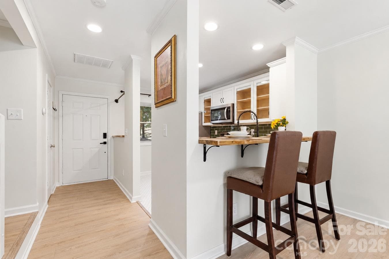 The breakfast bar creates a convenient setting for coffee, casual meals, and conversation. - 3858 Mosscroft Lane, Charlotte