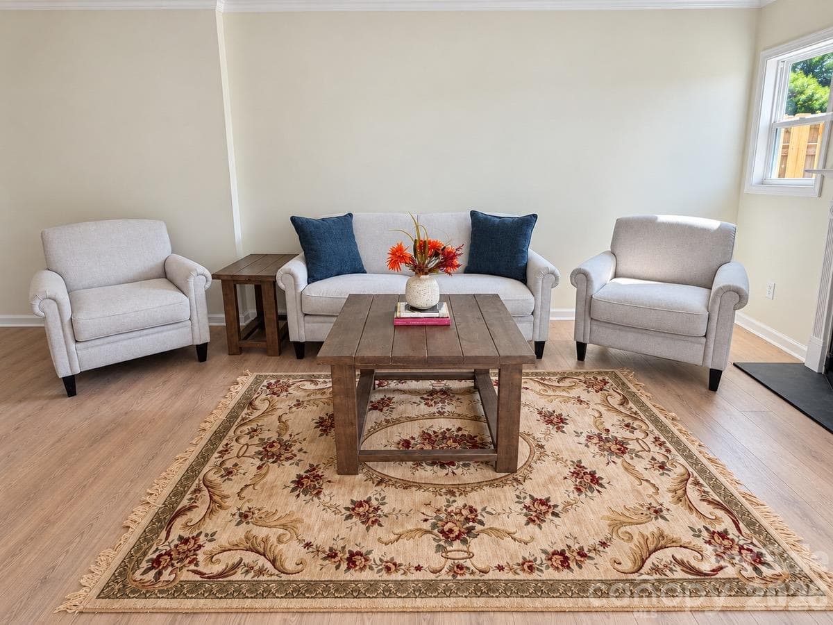 Sliding glass doors connect the living room to a fenced patio—perfect for enjoying a little fresh air. - 3858 Mosscroft Lane, Charlotte