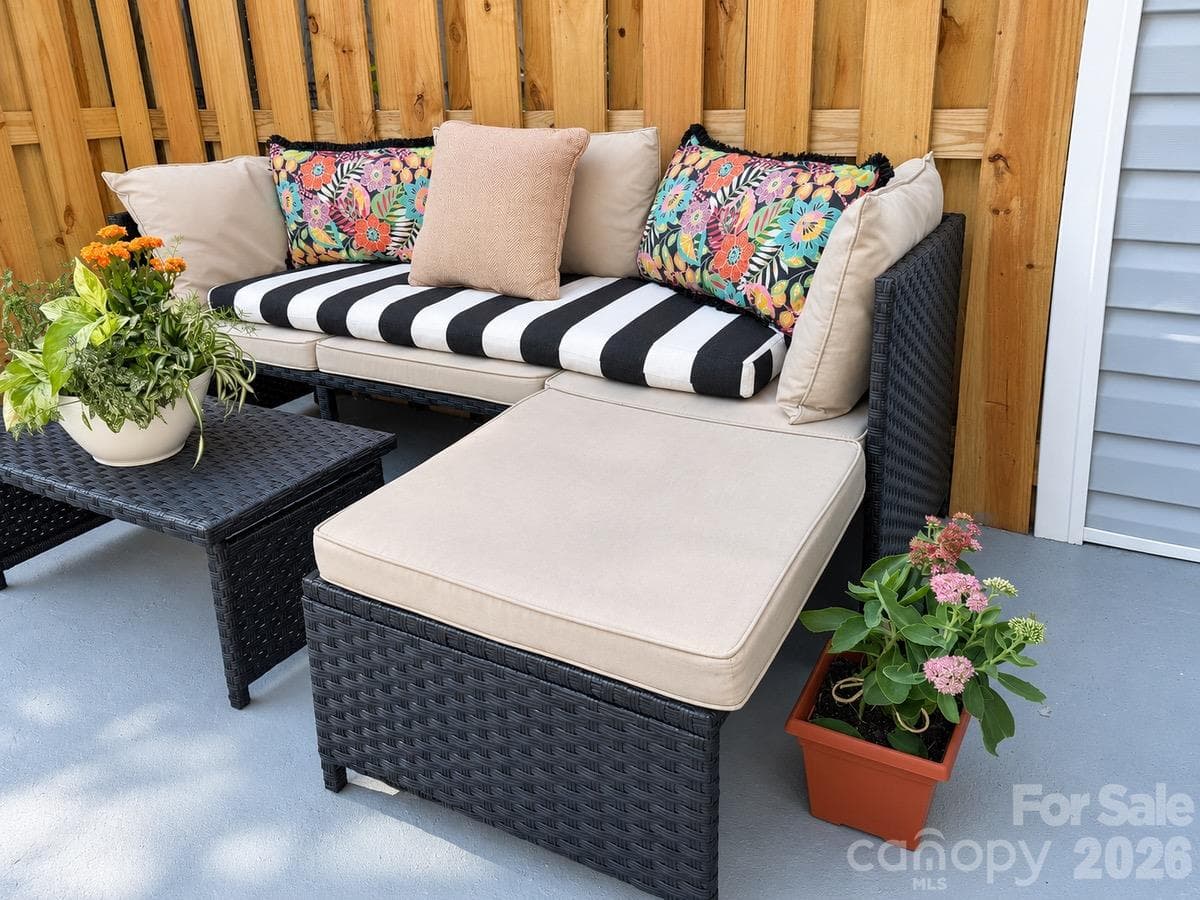 Enjoy outdoor dining and downtime on the paver patio, enclosed by new wood fencing. - 3858 Mosscroft Lane, Charlotte