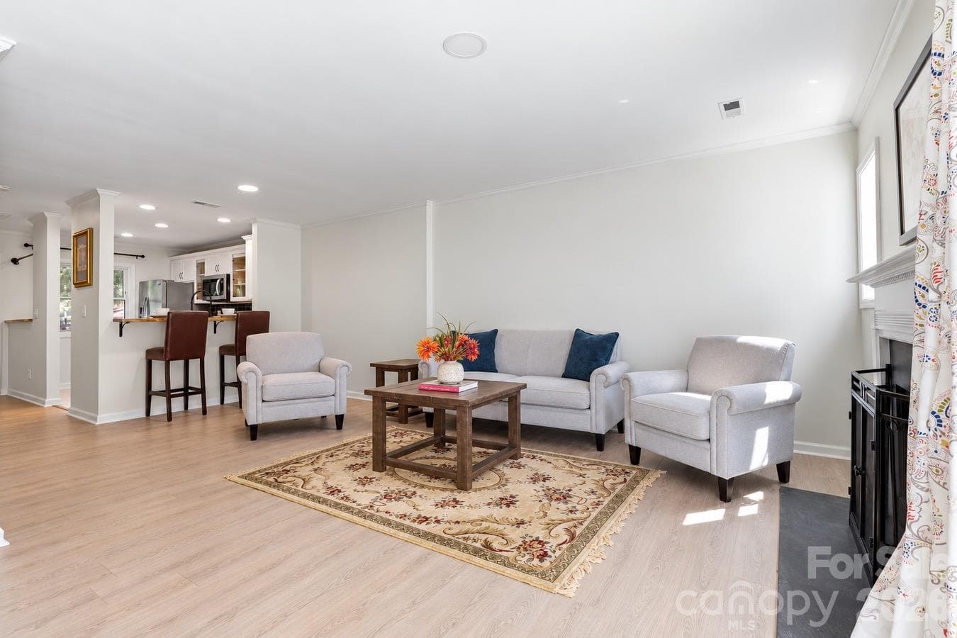 Inviting living space with updated flooring and an easy connection to the kitchen and breakfast bar. - 3858 Mosscroft Lane, Charlotte