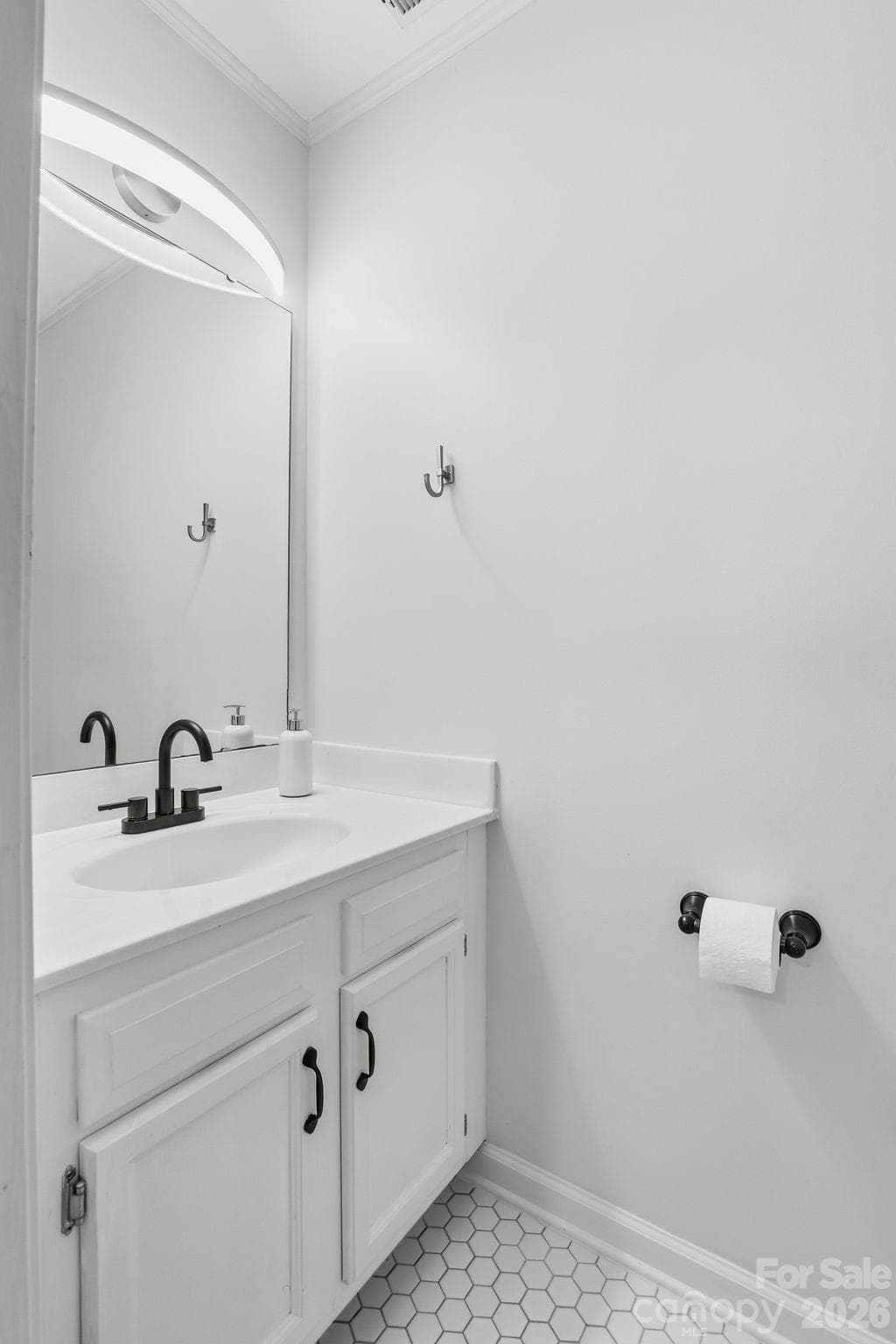 Convenient half bath near the front entrance, adjacent to a foyer closet for coats and everyday essentials. - 3858 Mosscroft Lane, Charlotte