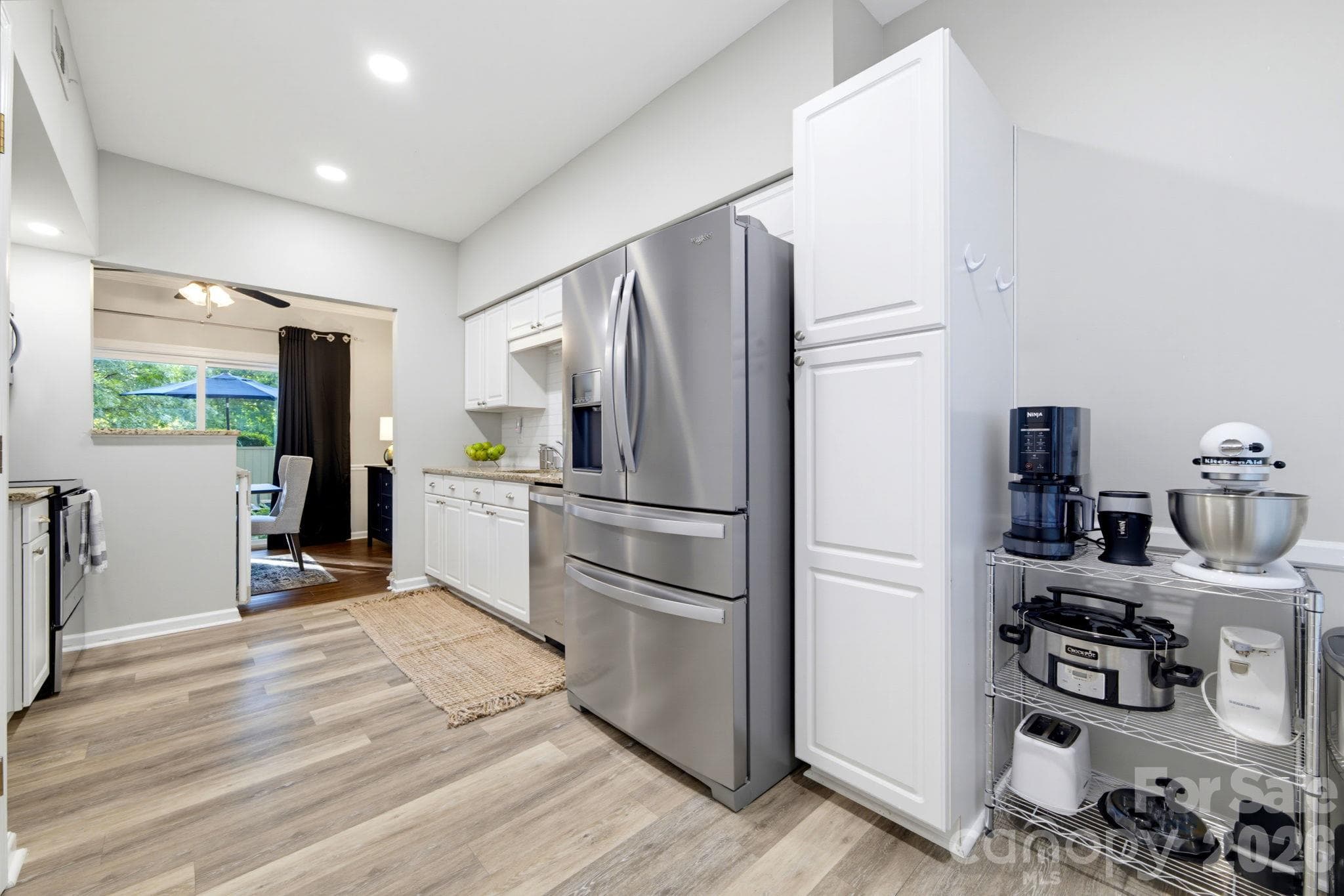 Additional kitchen view highlighting generous storage, including full-height pantry cabinetry with convenient pull-out shelving to maximize storage and accessibility - 5901 Quail Hollow Road, Charlotte