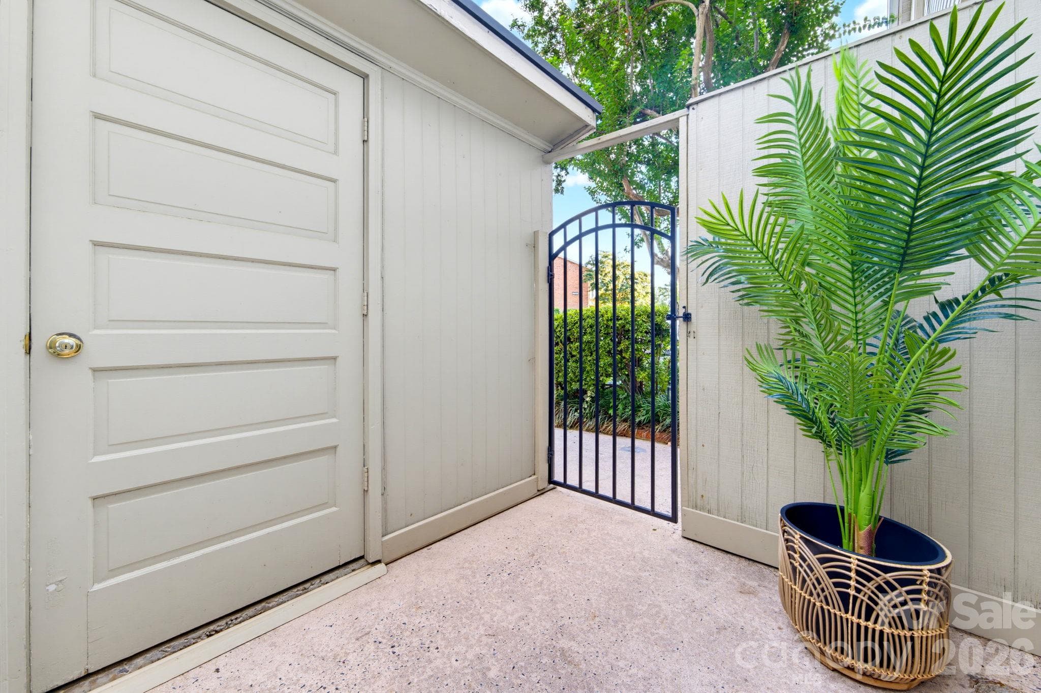 Additional front patio with direct access to the home and a spacious exterior storage area - 5901 Quail Hollow Road, Charlotte