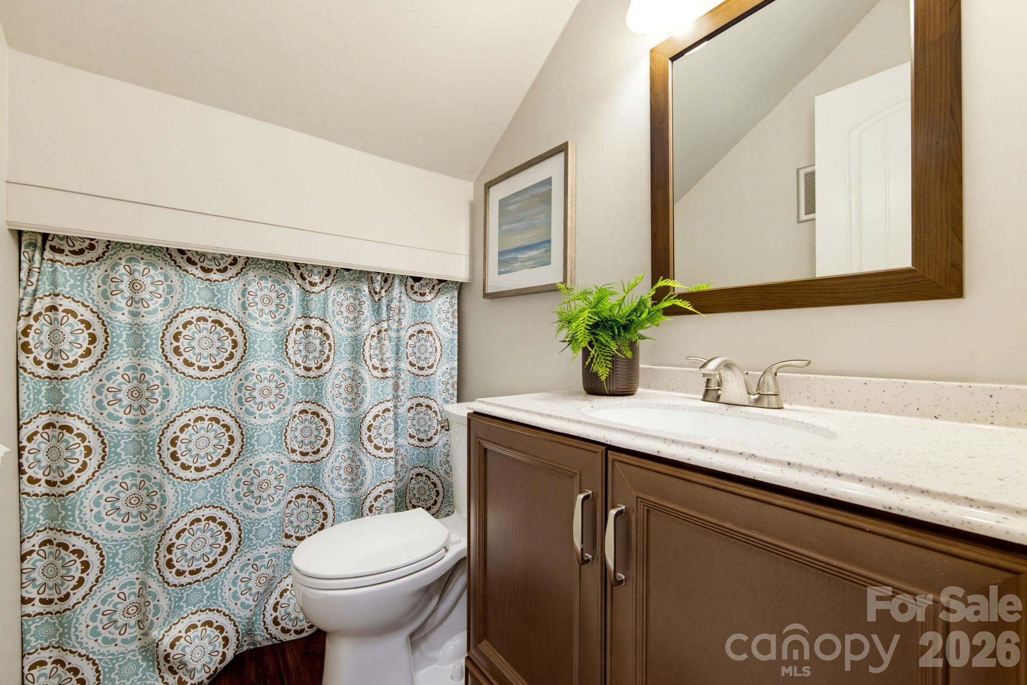 Powder room with new vanity, upated fixtures and lighting, plus convenient concealed storage. - 5901 Quail Hollow Road, Charlotte
