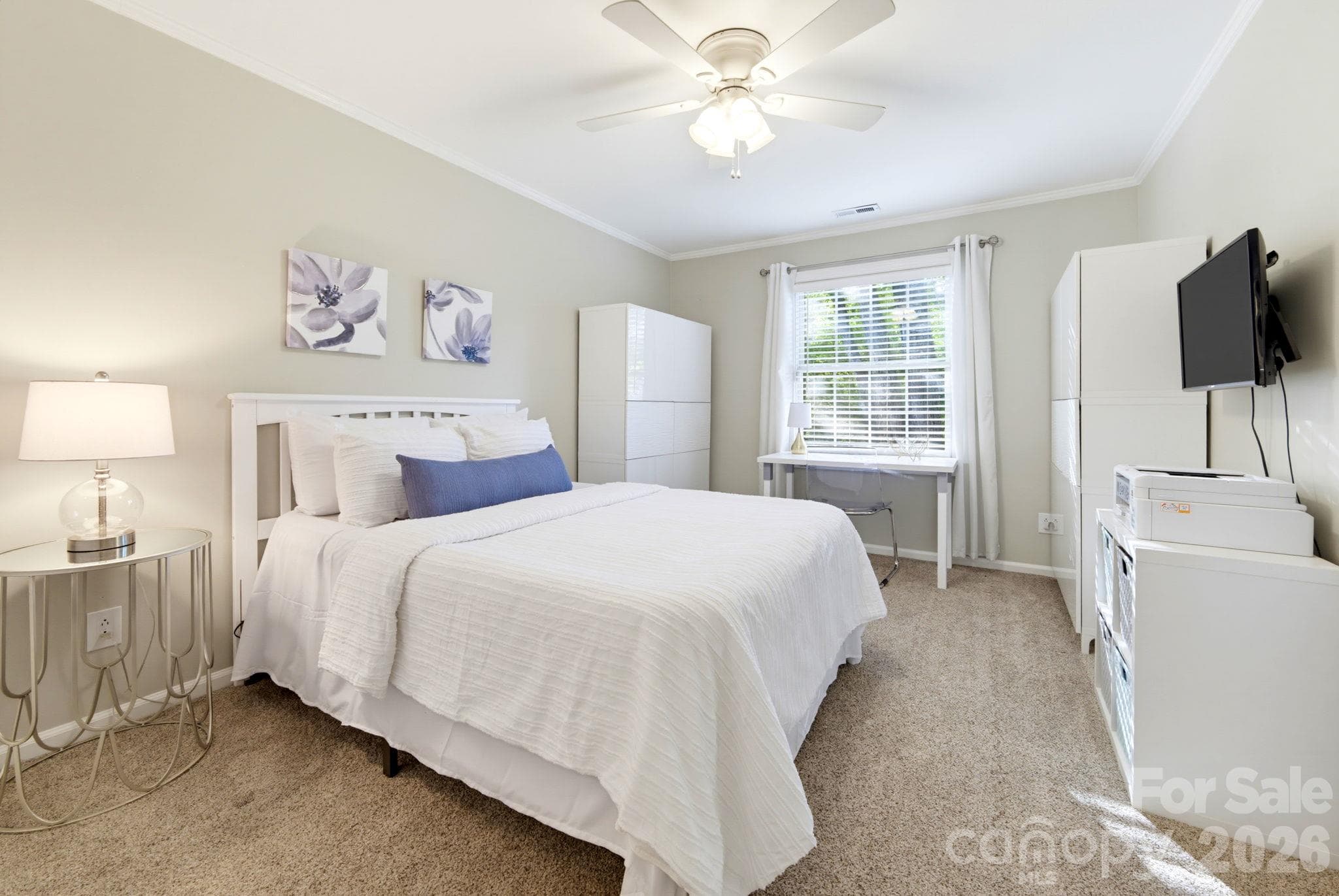 Comfortable secondary bedroom with relaxing views of the mature trees and space for a dedicated work-from-home area. - 5901 Quail Hollow Road, Charlotte