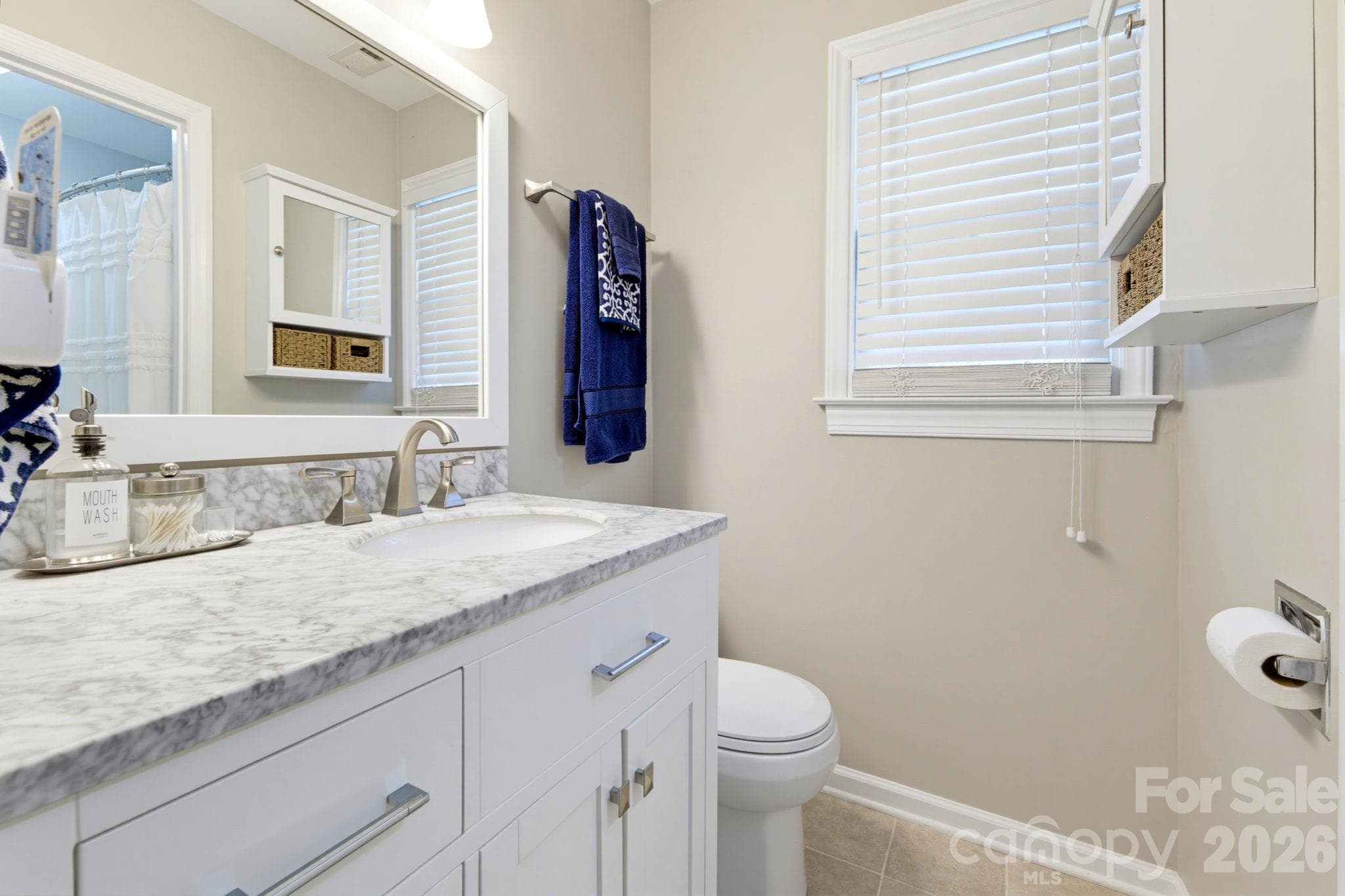 New primary bath vanity with generous drawer and cabinet storage and updated fixtures. - 5901 Quail Hollow Road, Charlotte