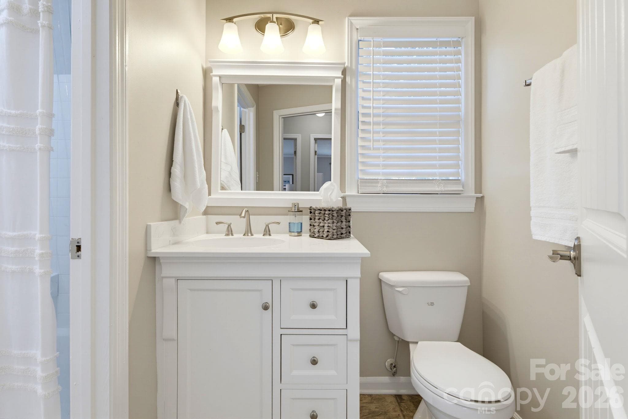 New guest bath vanity with storage, also with updated fixtures. - 5901 Quail Hollow Road, Charlotte
