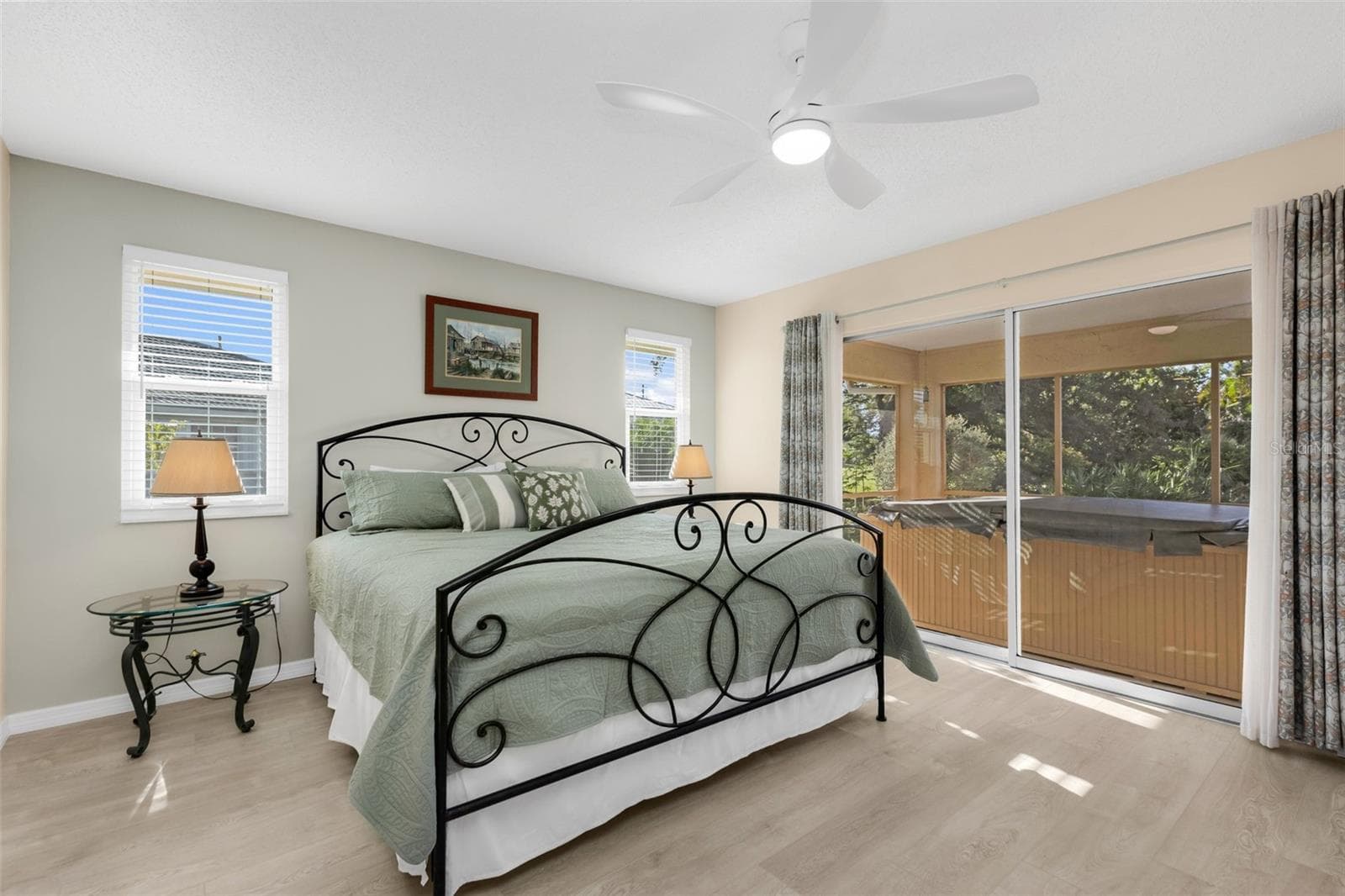 Primary bedroom with sliders to lanai and spa just steps away. - 1311 TUSCANY DR, PUNTA GORDA