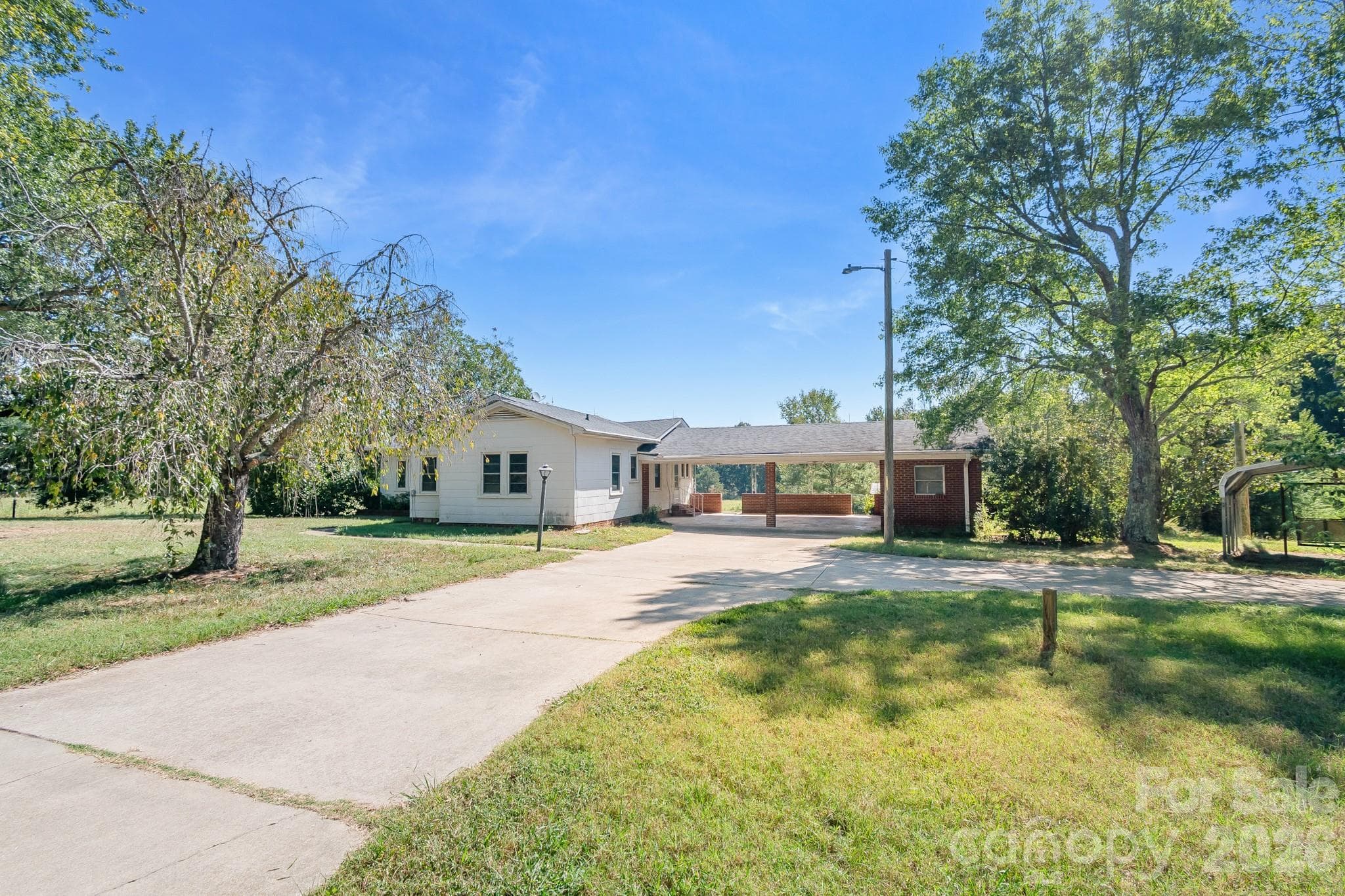 Main entry with circular driveway - 7615 S Rocky River Road, Monroe