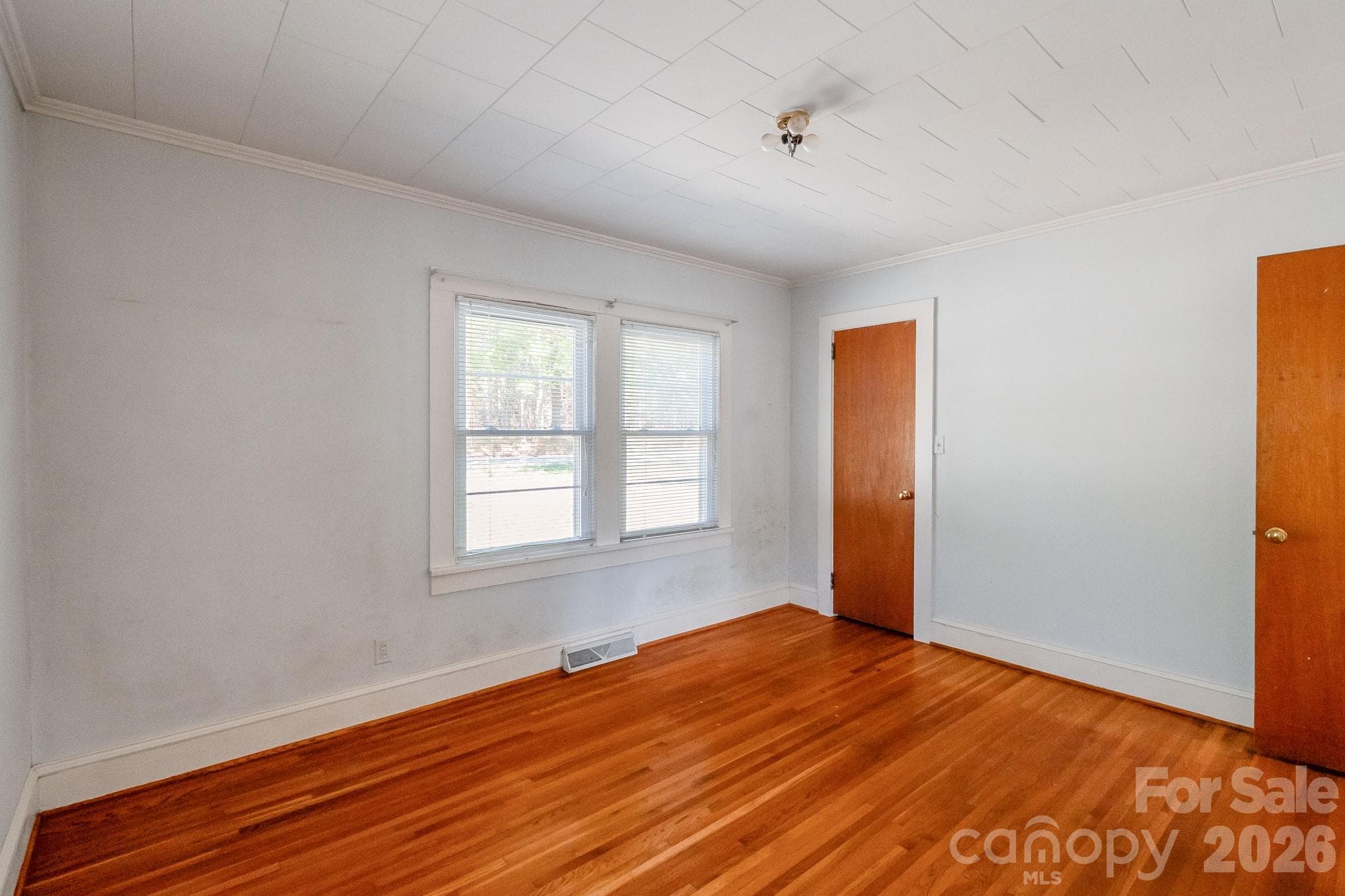 Front bedroom with original hardwoods - 7615 S Rocky River Road, Monroe